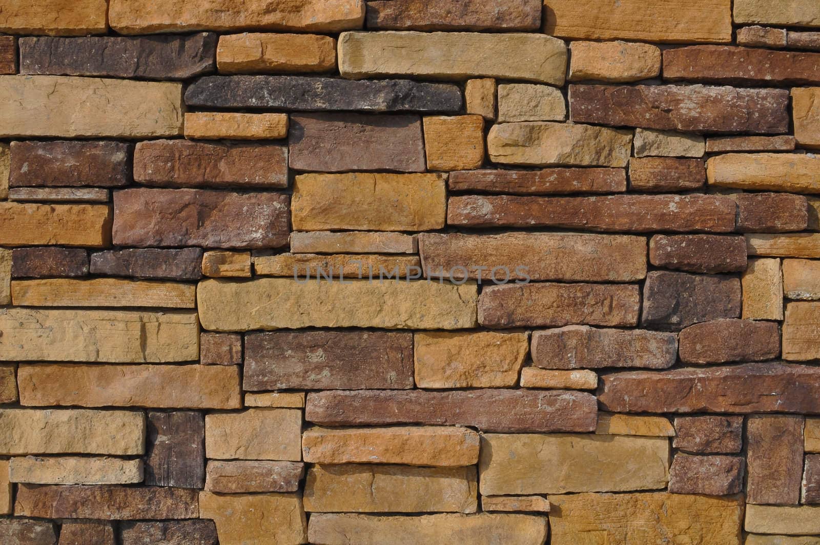 Wall of Multi Colored Stone used as a background