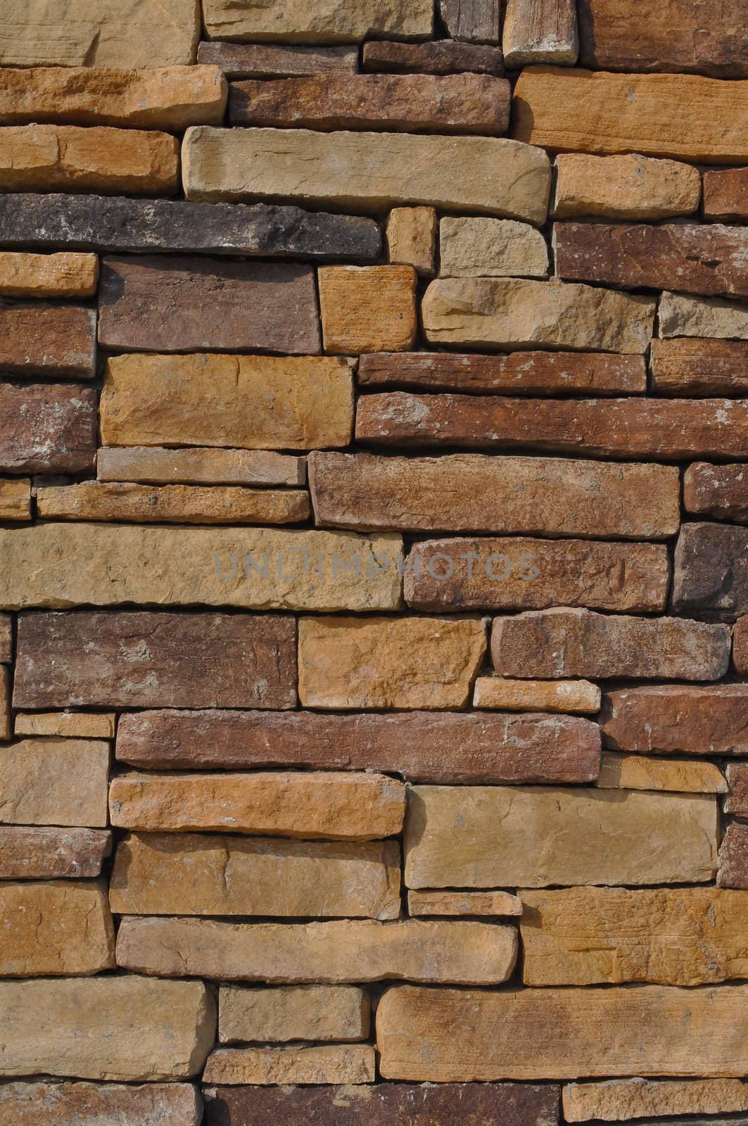 Wall of Multi Colored Stone used as a background