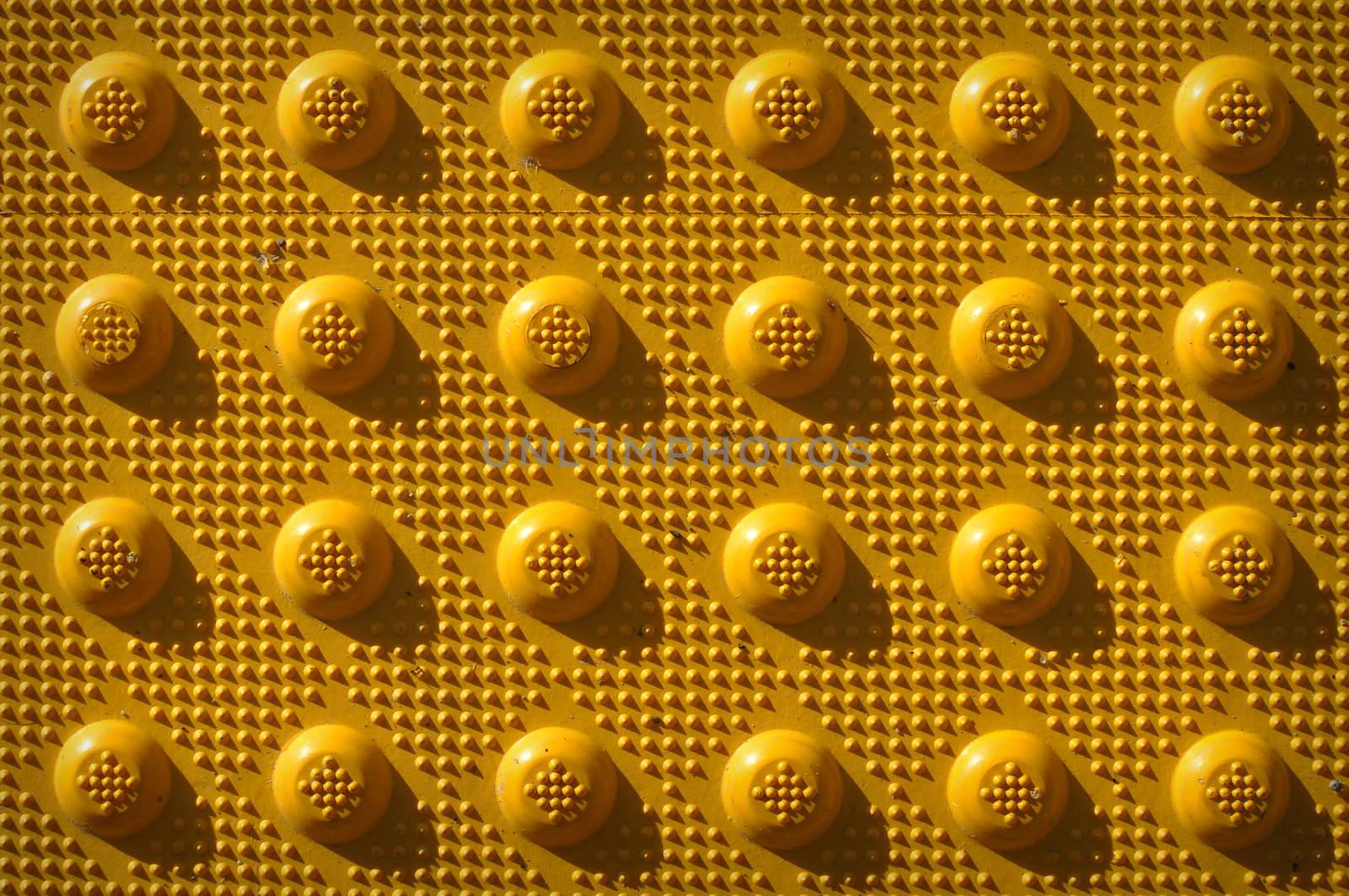 Yellow Repeating Knob Pattern used as a background to add text