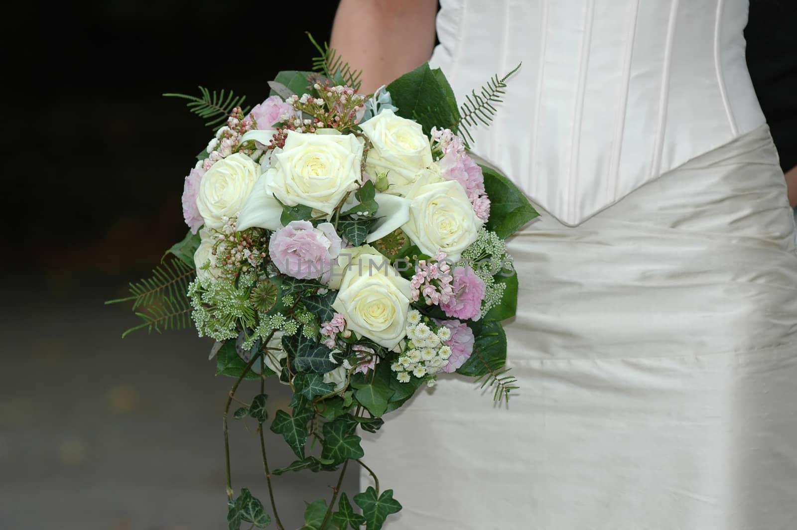 Bride is holding her wedding bouquet.