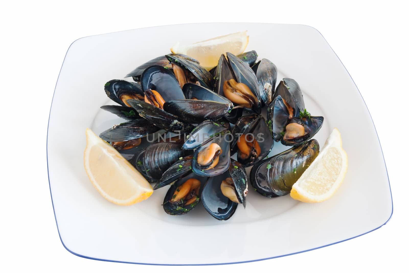 cooked mussels on a plate with lemon isolated with clipping path