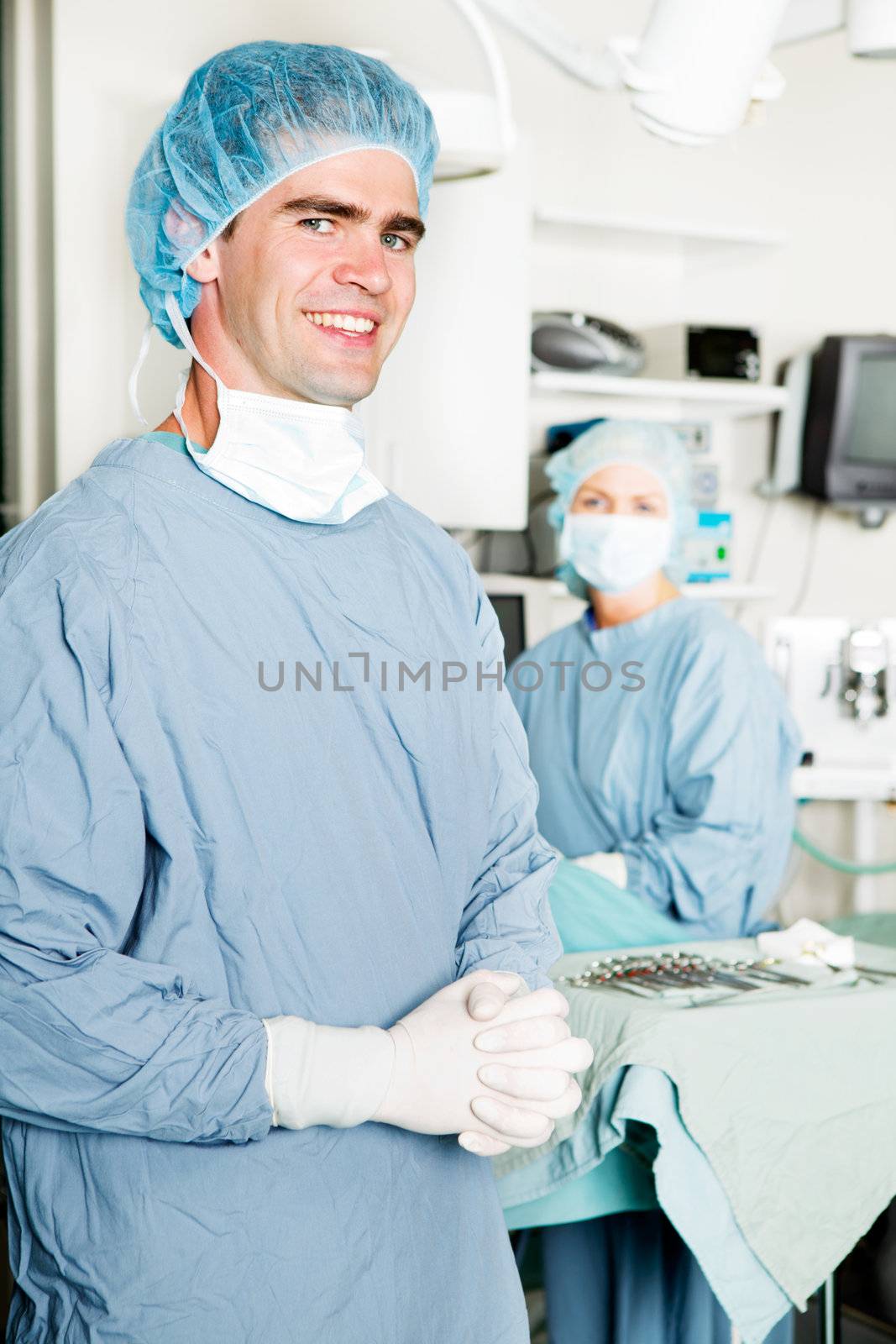 A portrait of a male surgeon with an opration theater in the background