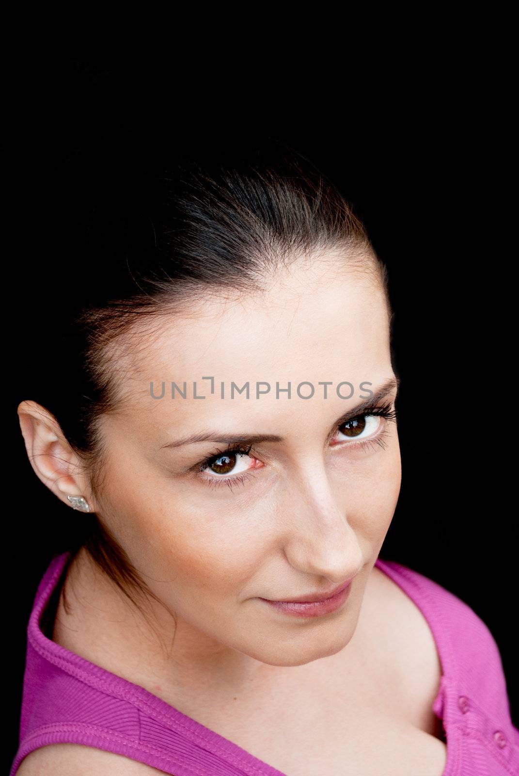 Portrait of a beautiful young brunette, isolated on black.