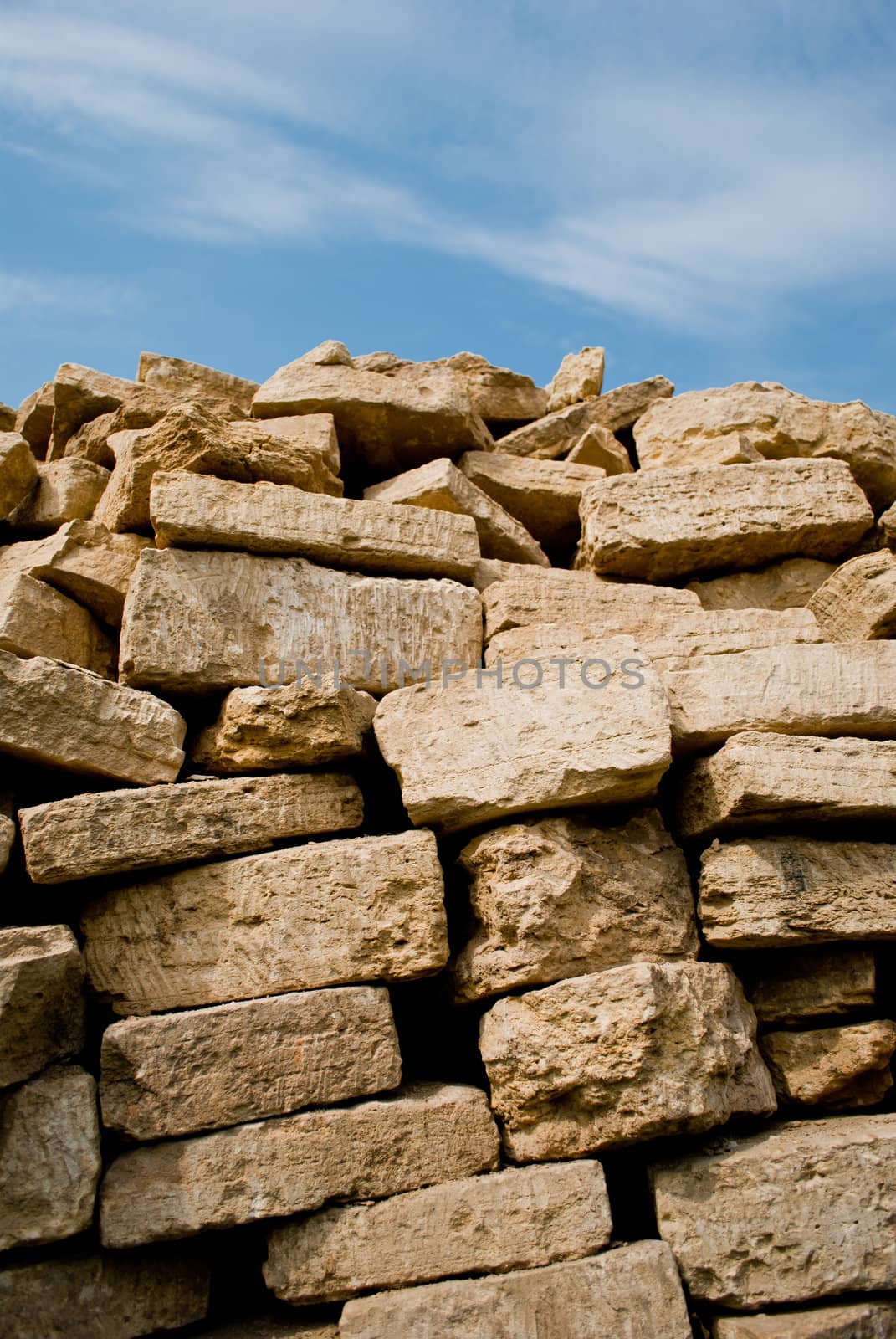 Stacked pile of bricks  under the sky.