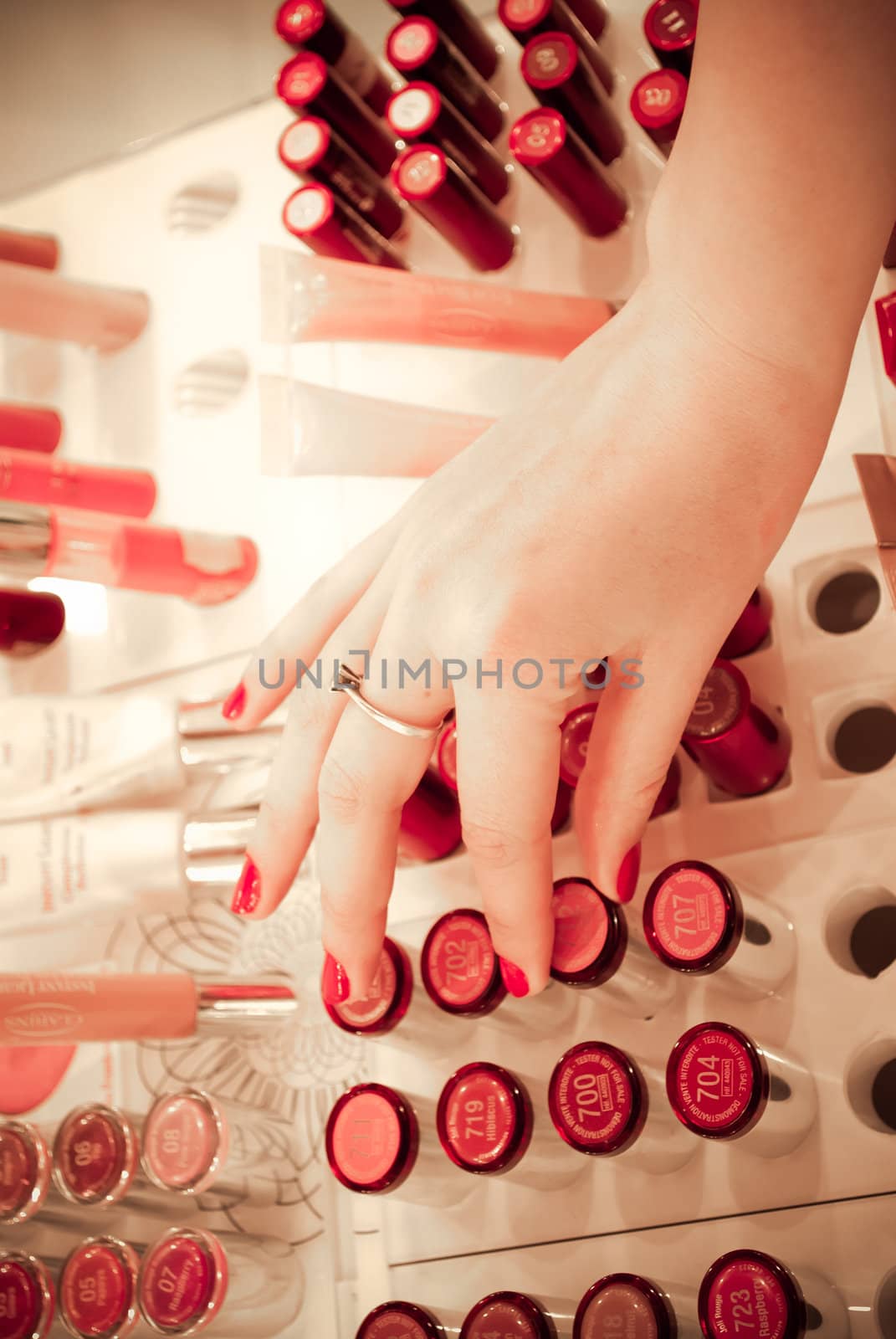 Young woman selecting make-up in a beauty store.