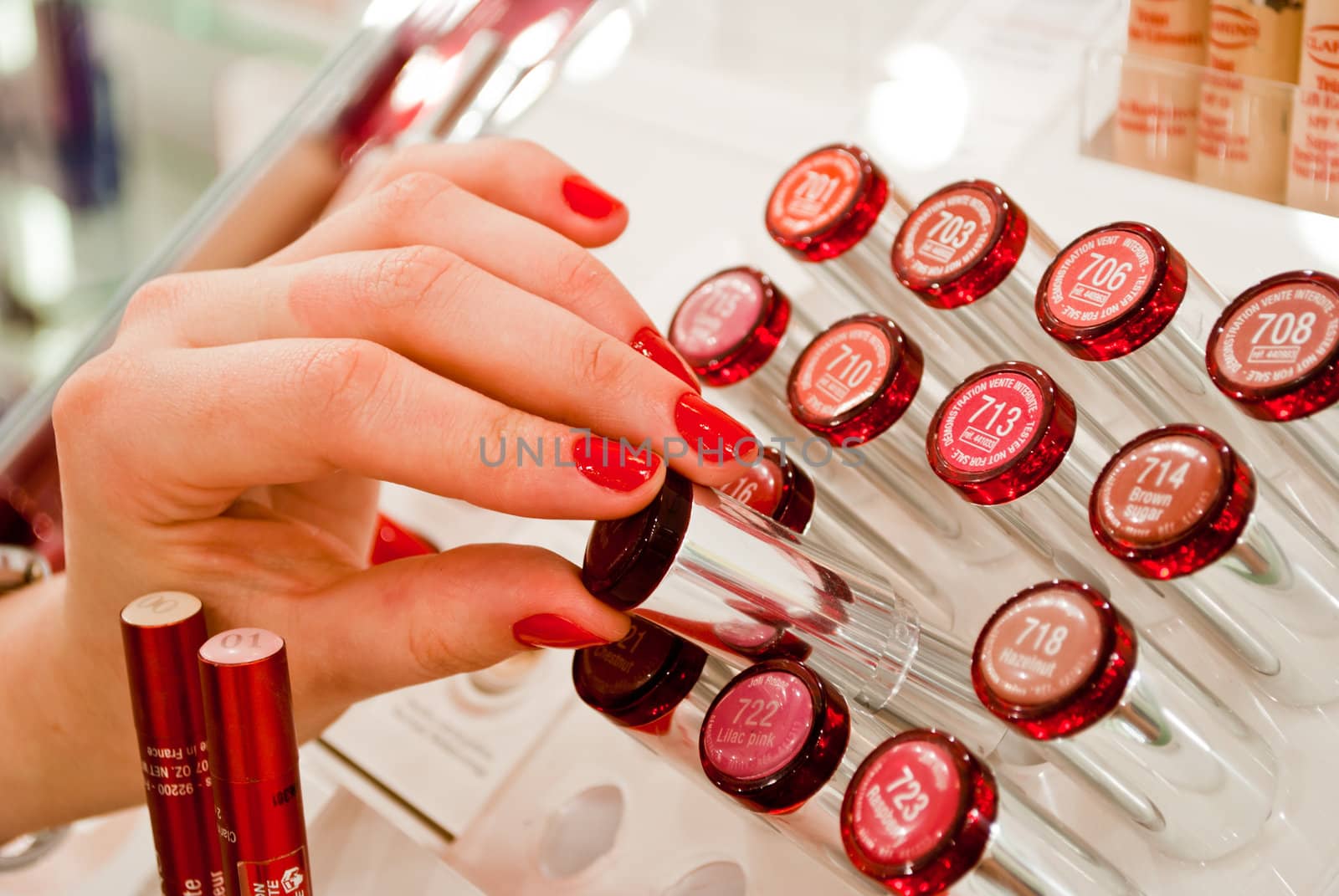 Young woman selecting make-up in a beauty store.