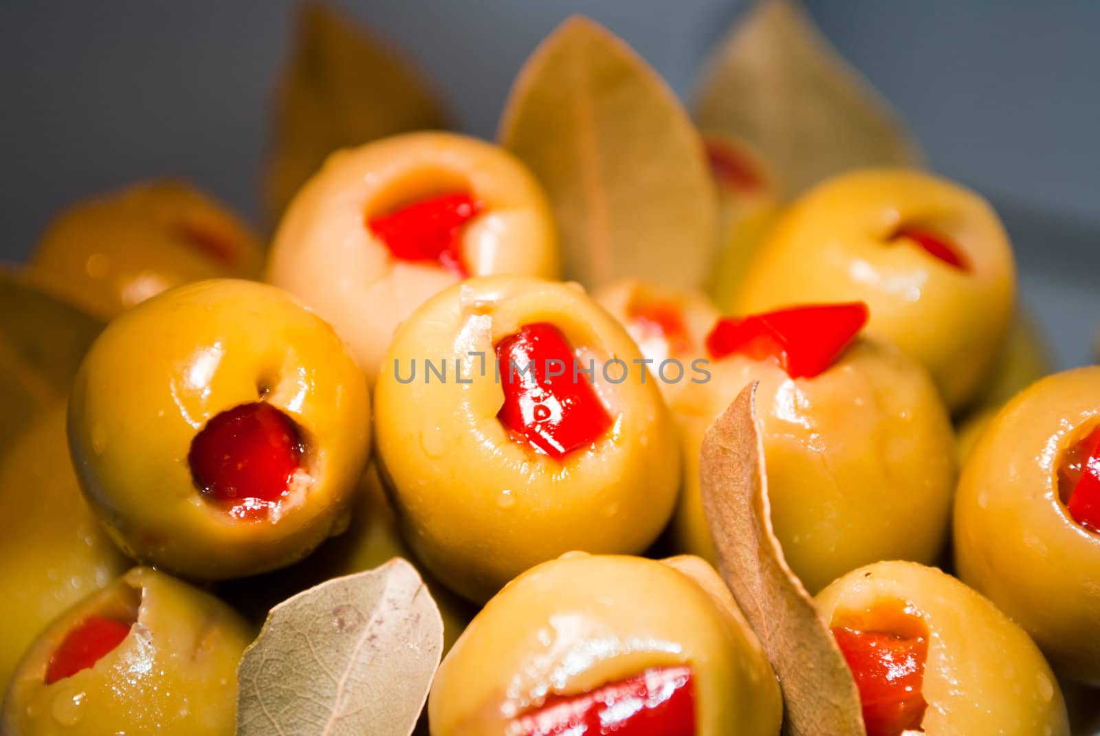 Green olive fruits stuffed with red pepper
