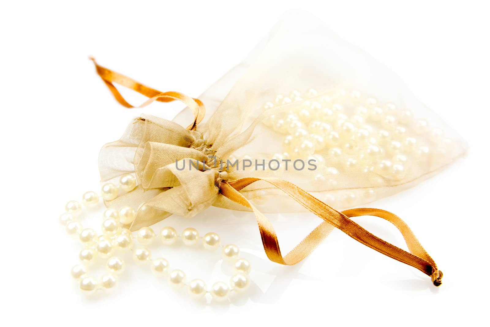 White pearls in a bag, isolated on white background.