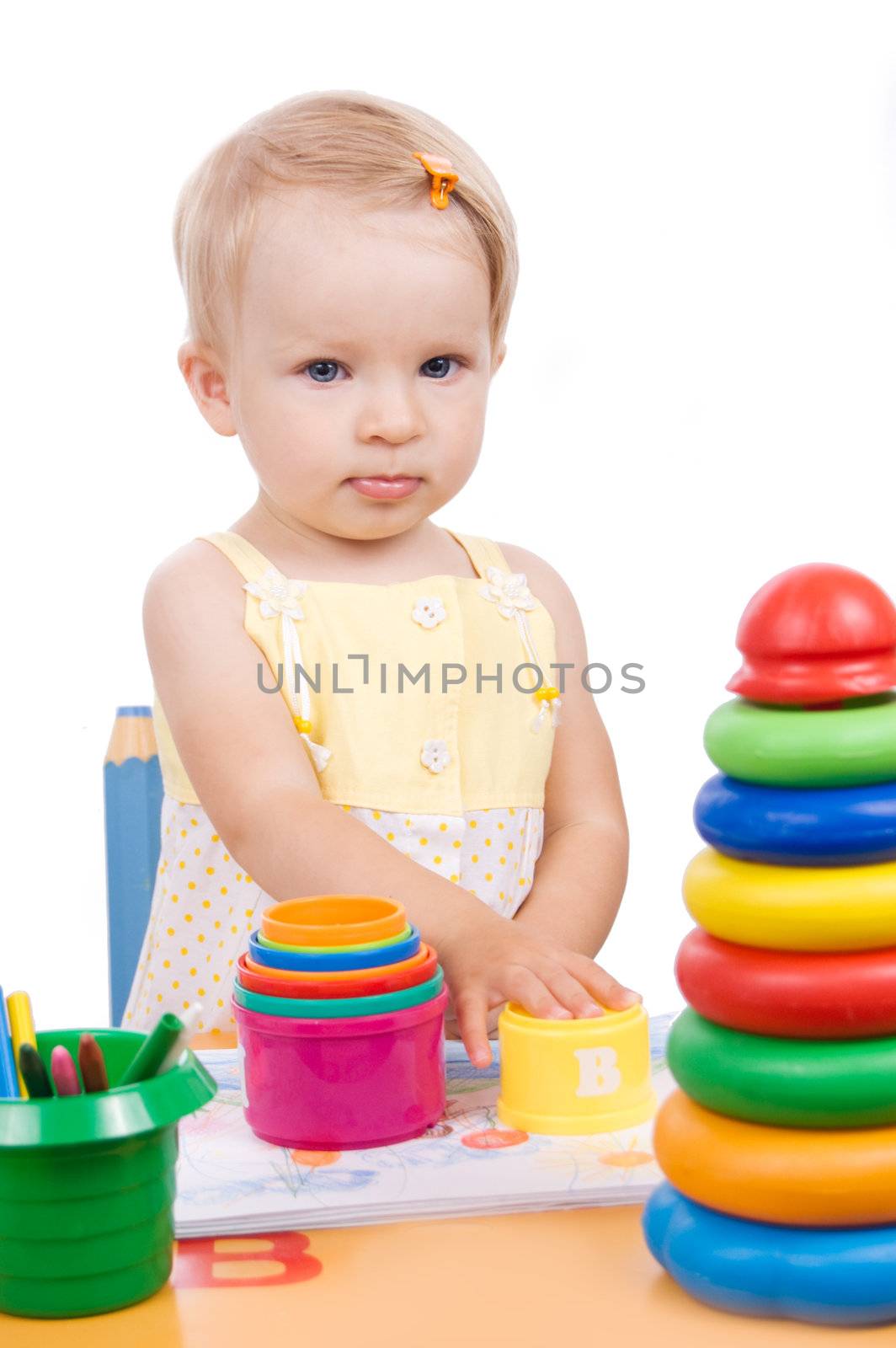 Baby girl playing at table over white