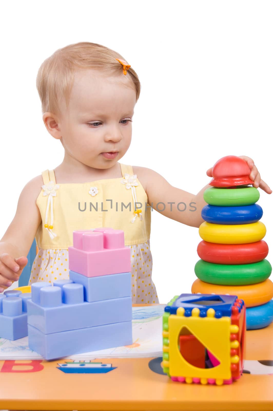 Baby girl playing pyramid over white