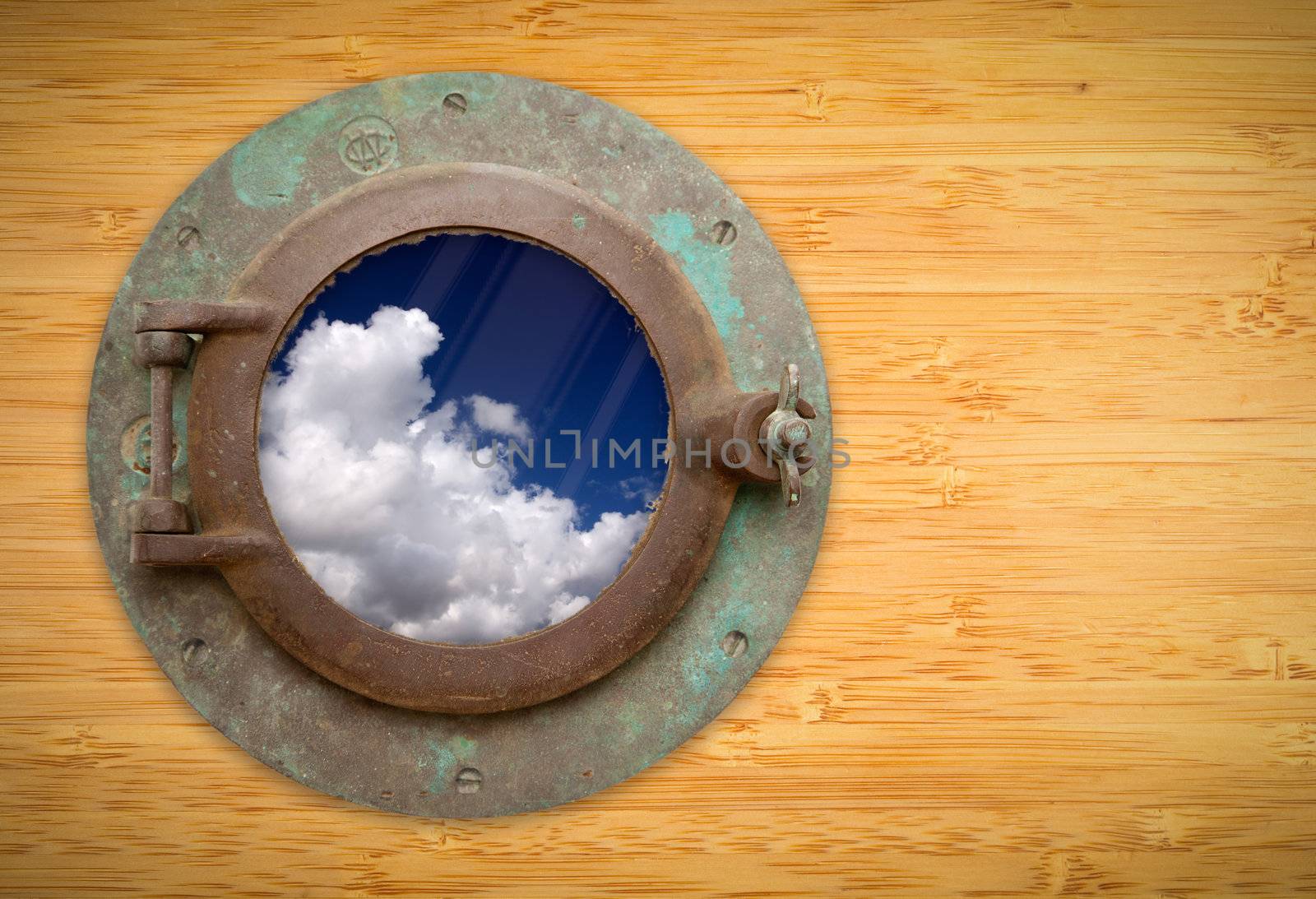 Antique Porthole on Bamboo Wall with View of Beautiful Blue Sky and Clouds.