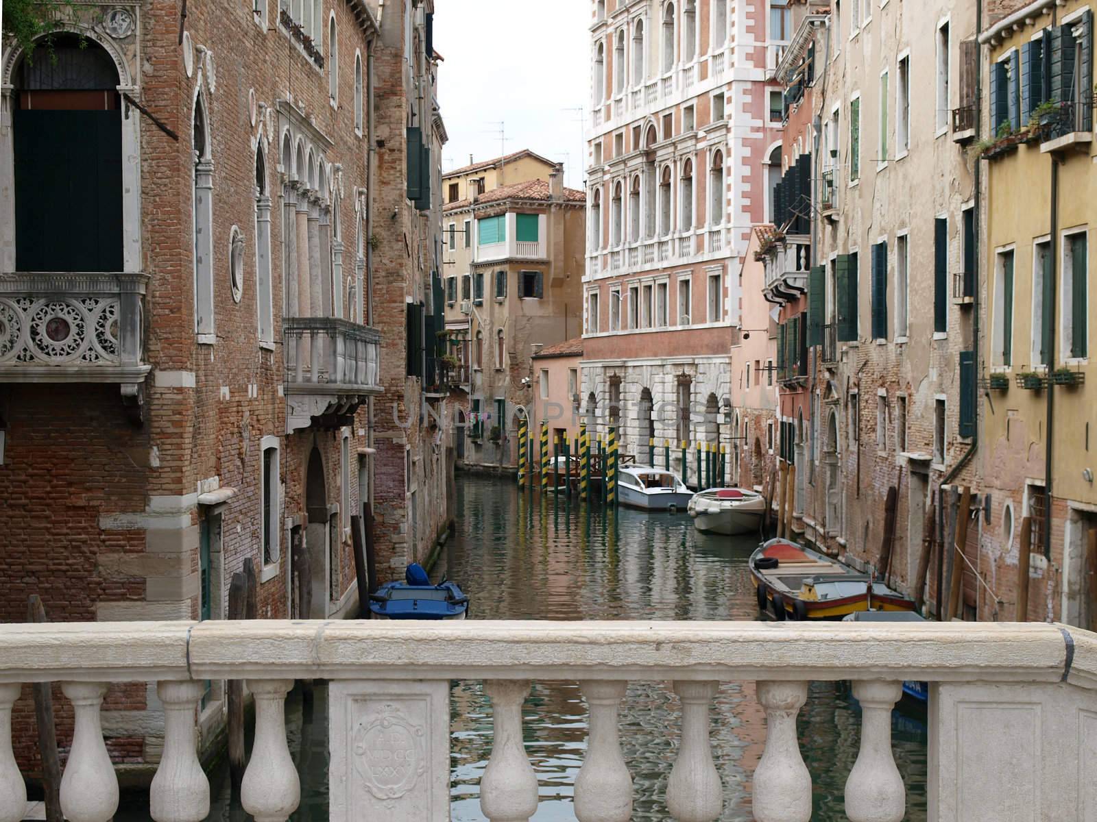  Venice - Typical Venetian scene with houses and narrow canal. 