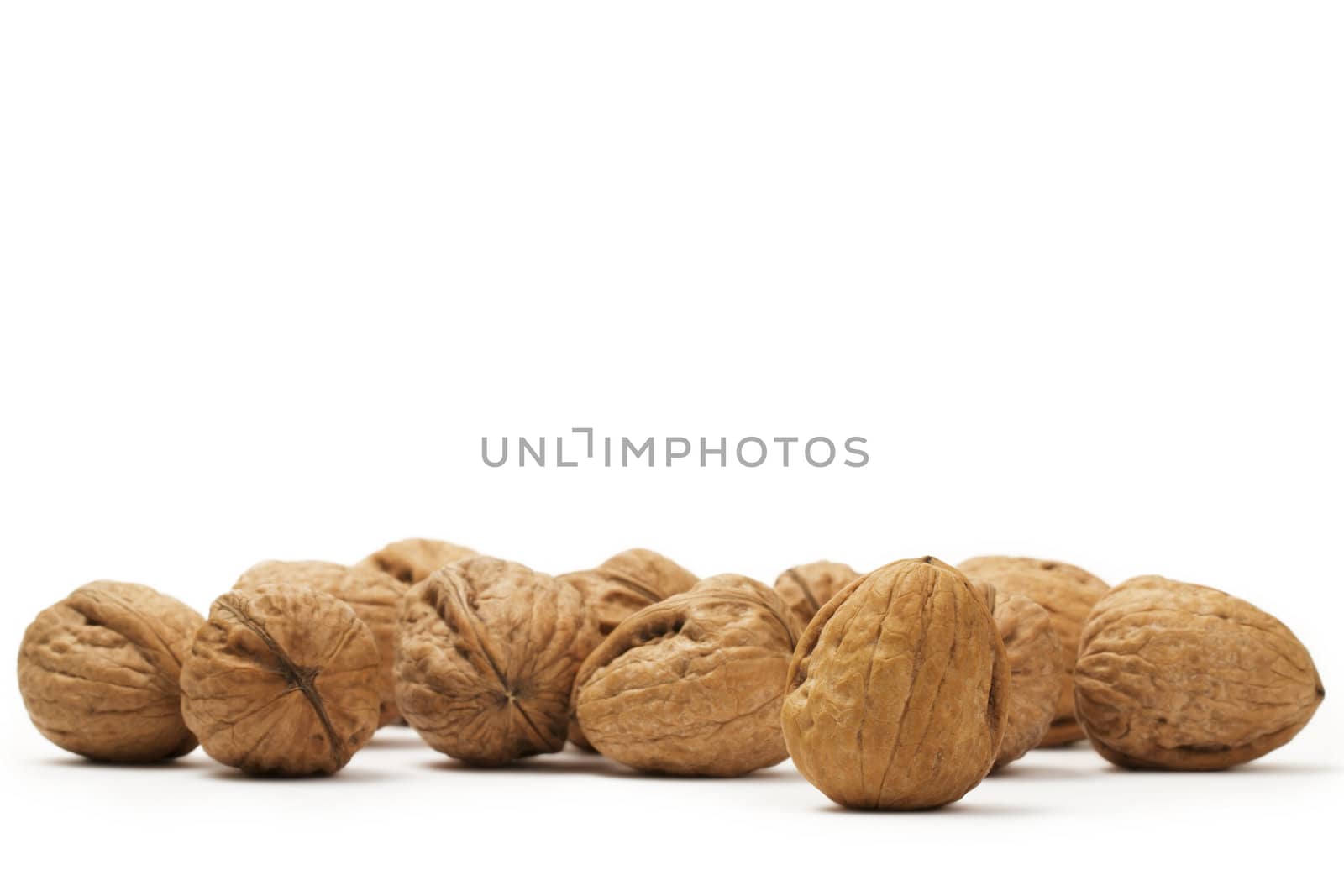a lot of walnuts on white background