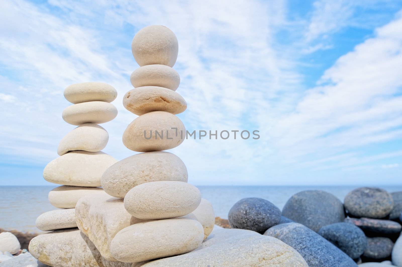 Two pile of pebbles in the balance on the seacoast