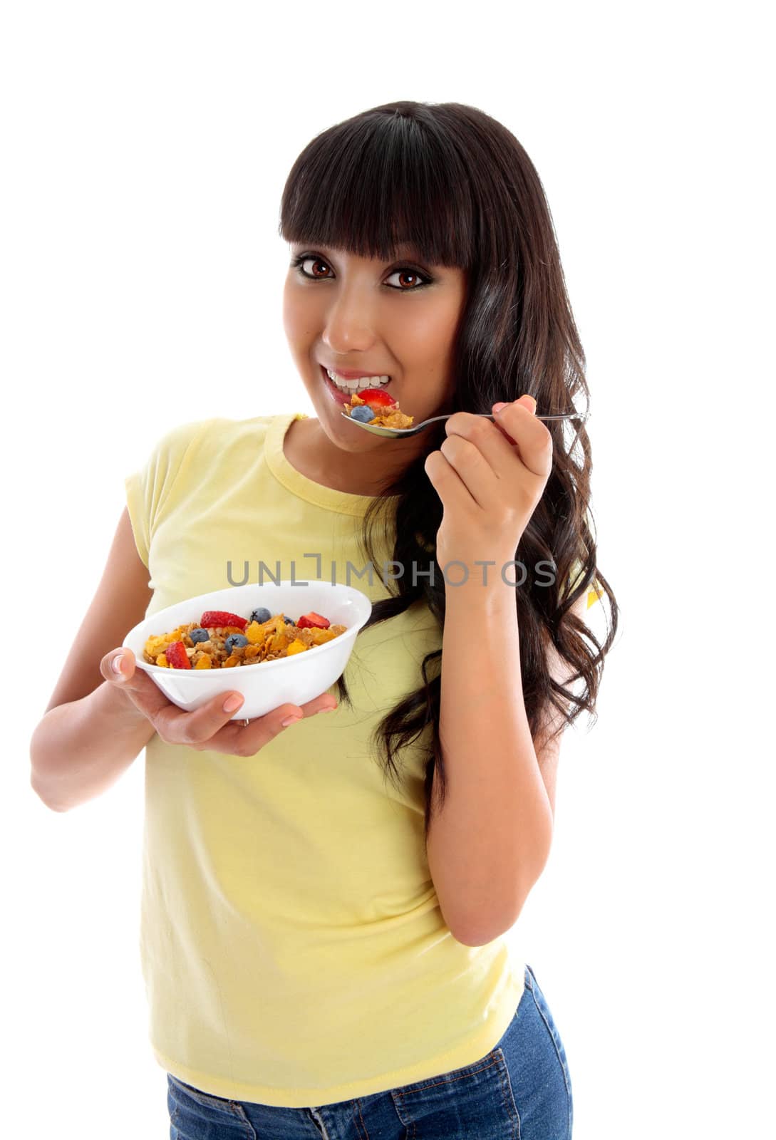 Smiling woman eating cereal breakfast by lovleah