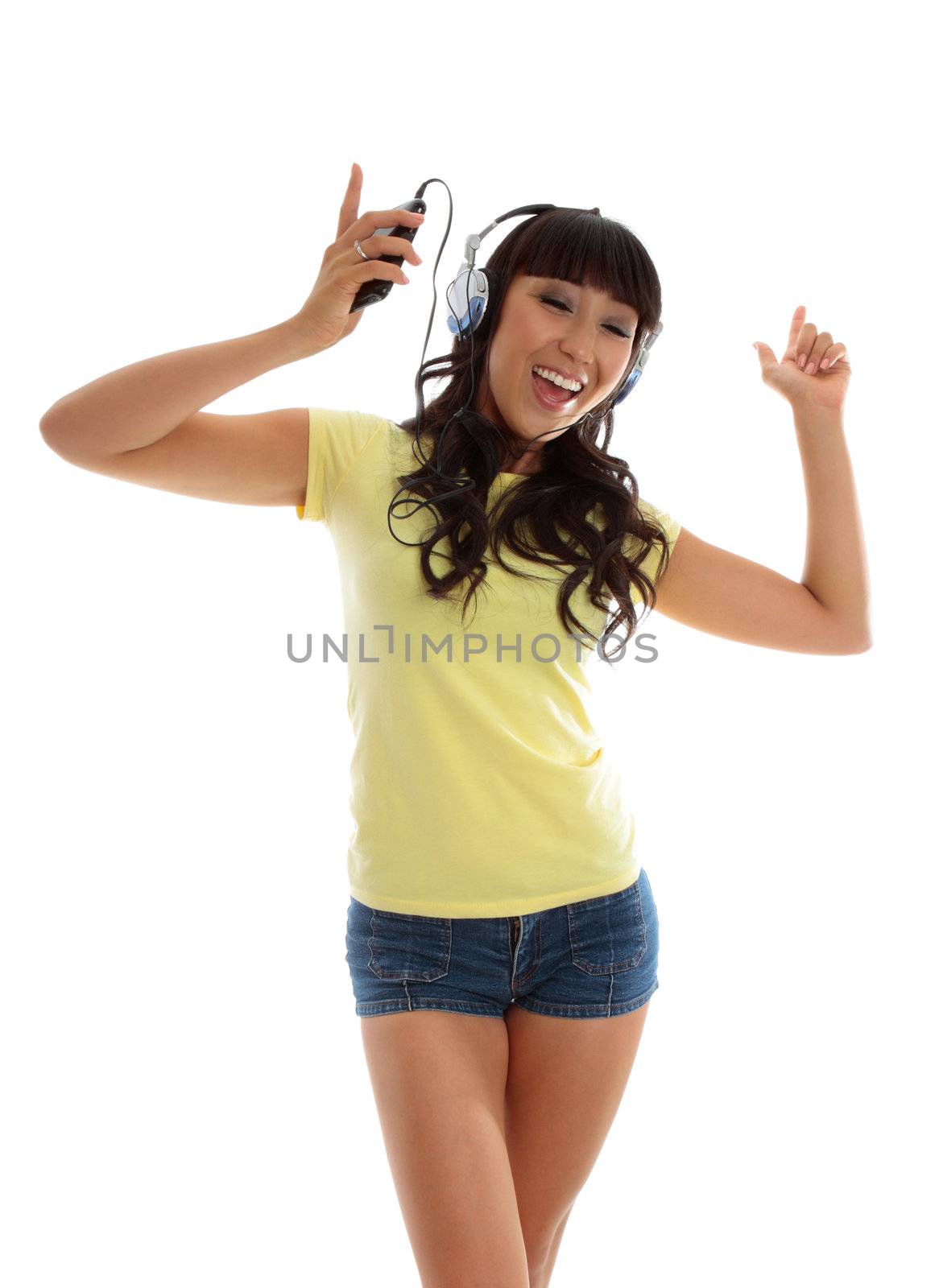 A vivacious active young woman dancing and listening to music