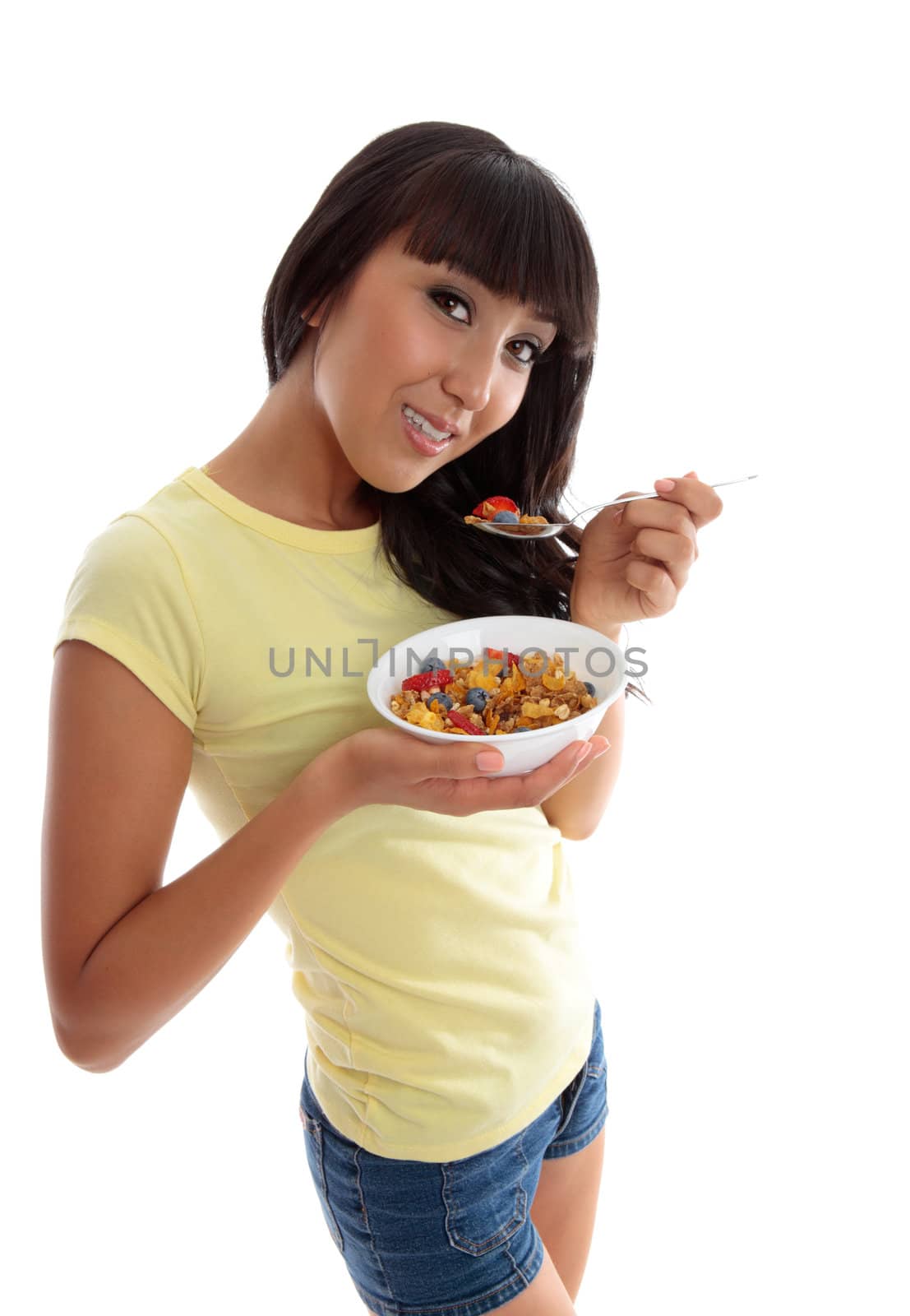 A young smiling woman eating a nutritious healthy breakfast.  White background