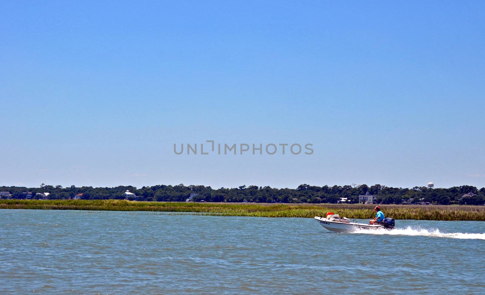 Boating across the water by RefocusPhoto
