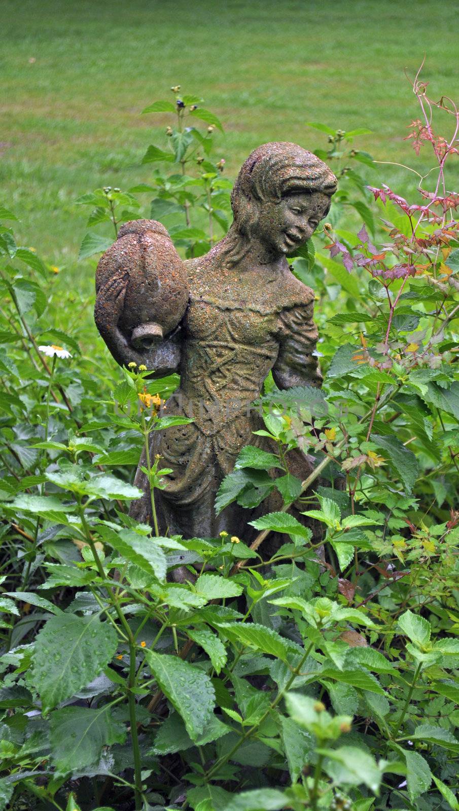 Girl statue in a garden by RefocusPhoto