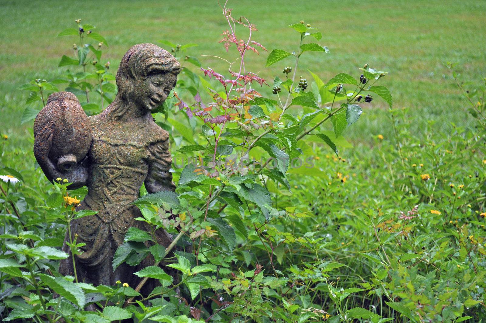 Girl statue in garden - background