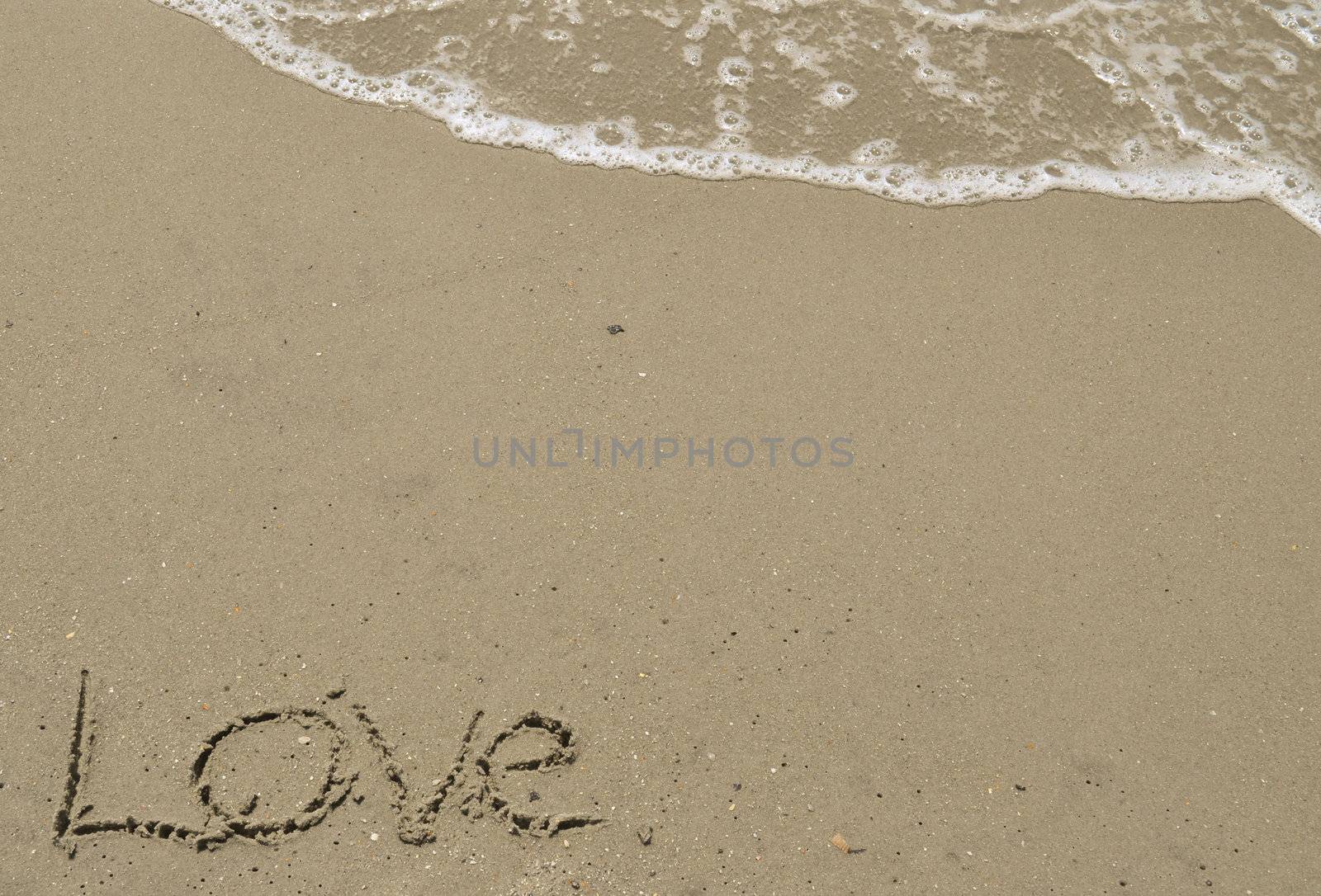 Love written in the sand with wave 2 by RefocusPhoto