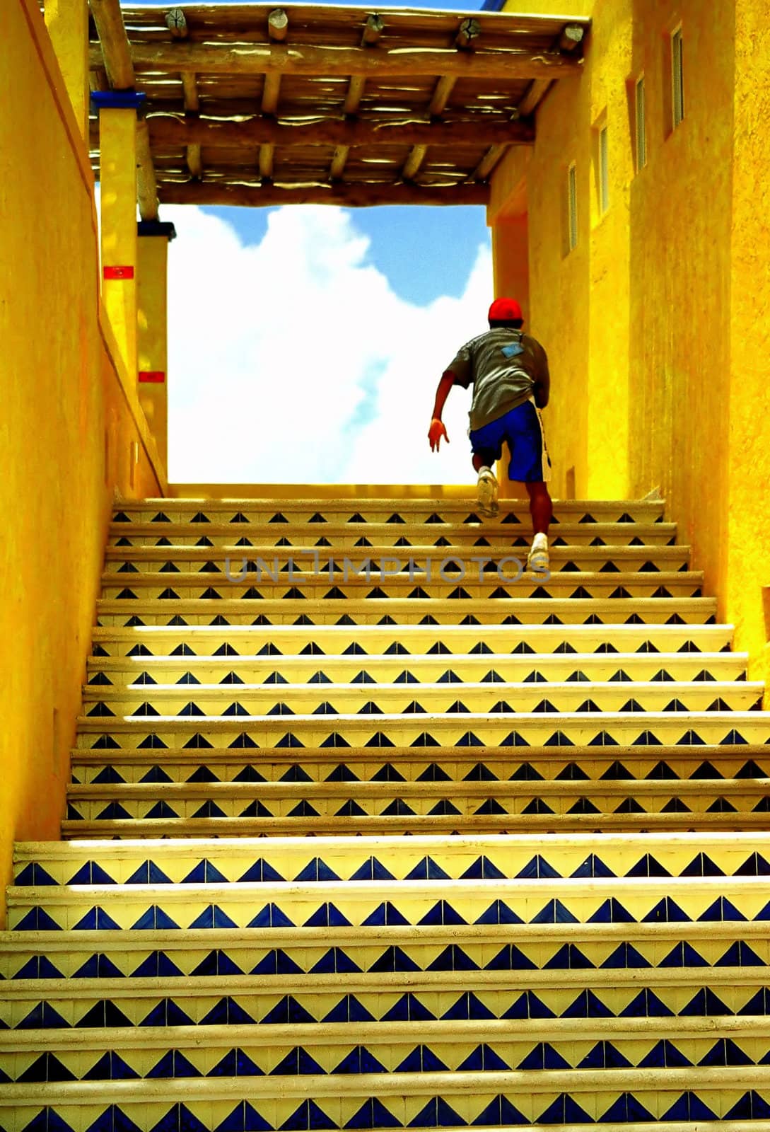 Boy running up some colorful stairs.