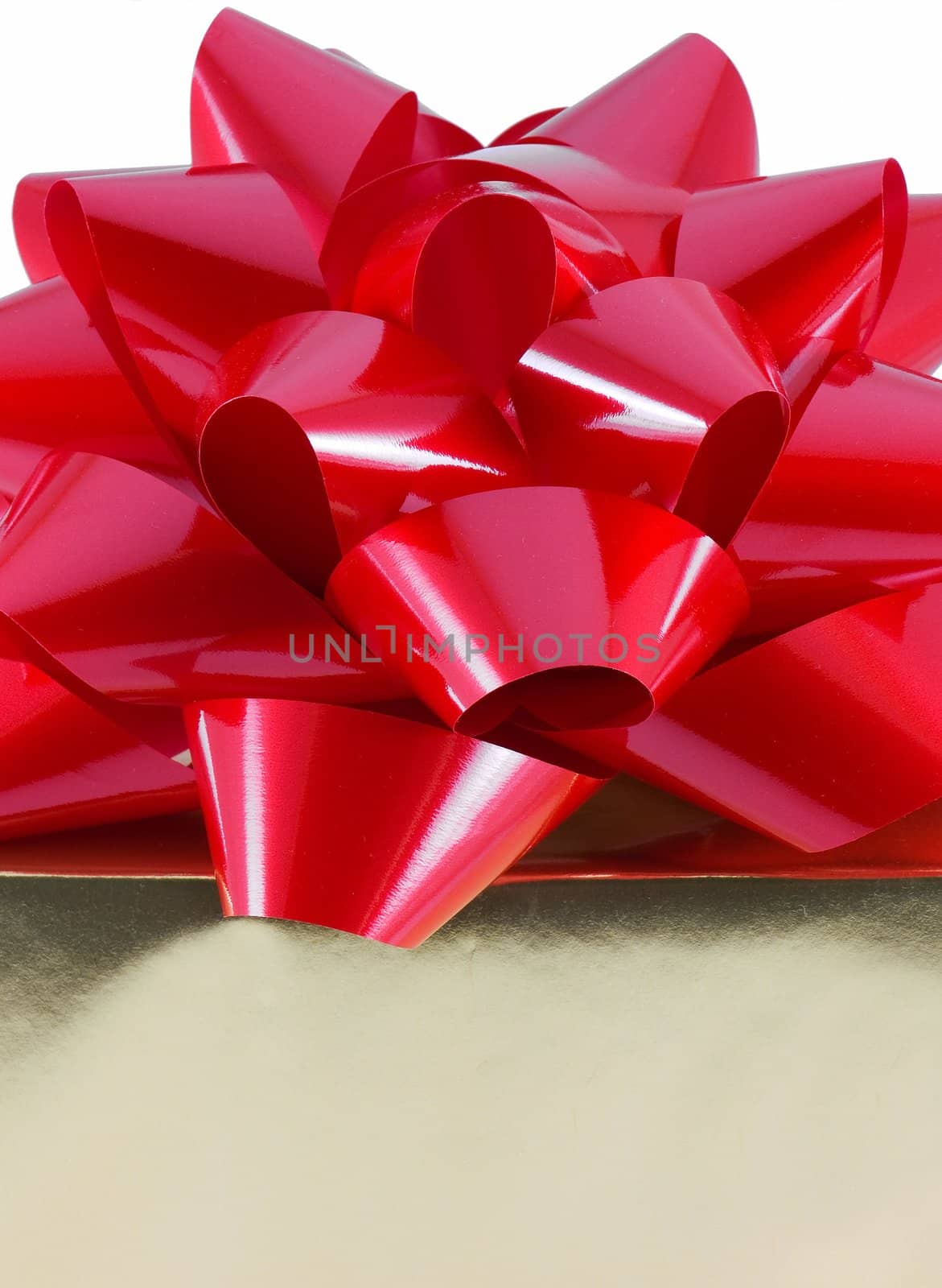 Christmas present wrapped with a large red bow on top, isolated on white