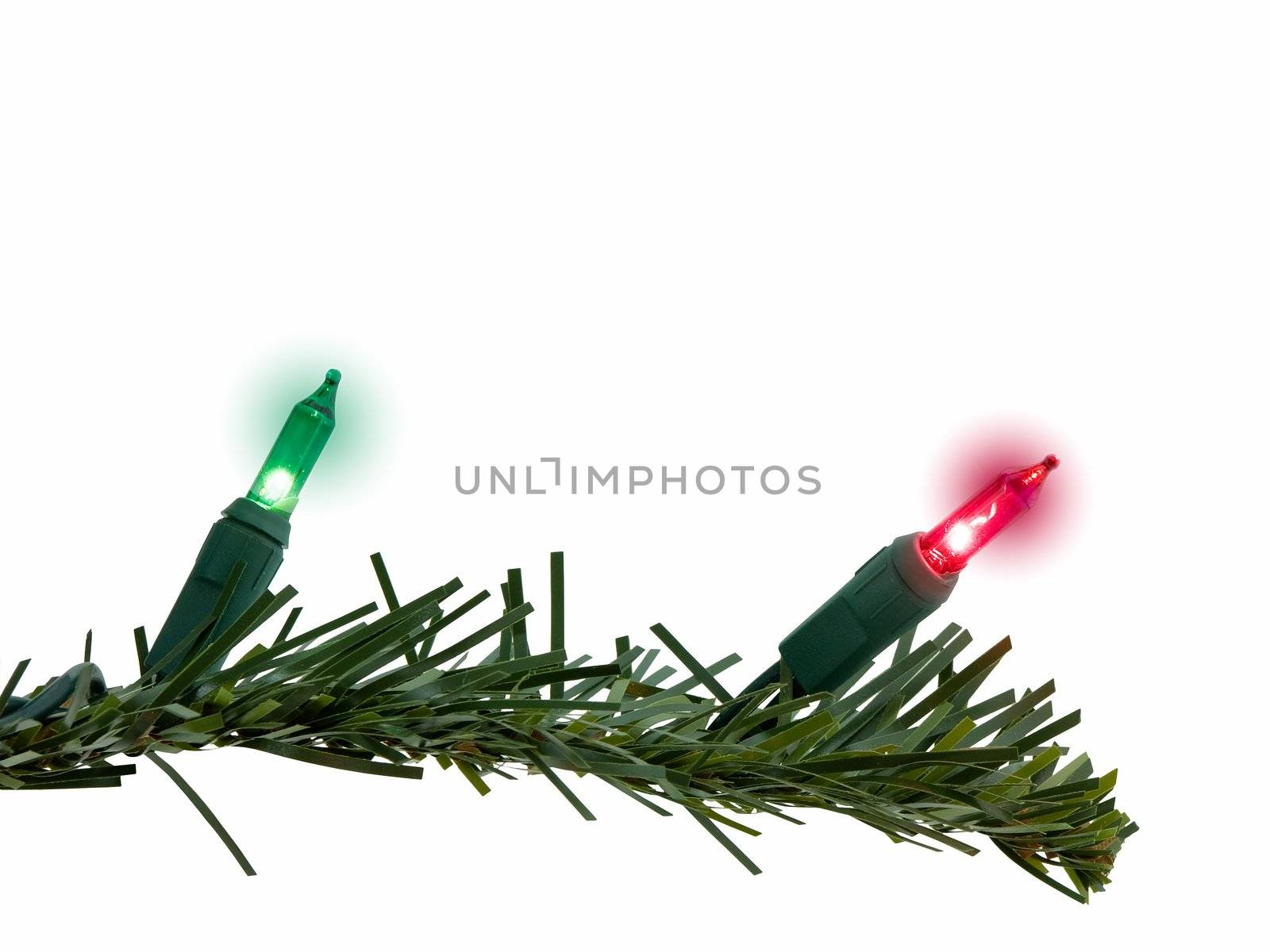 Red and green christmas lights on tree limb, isolated on white