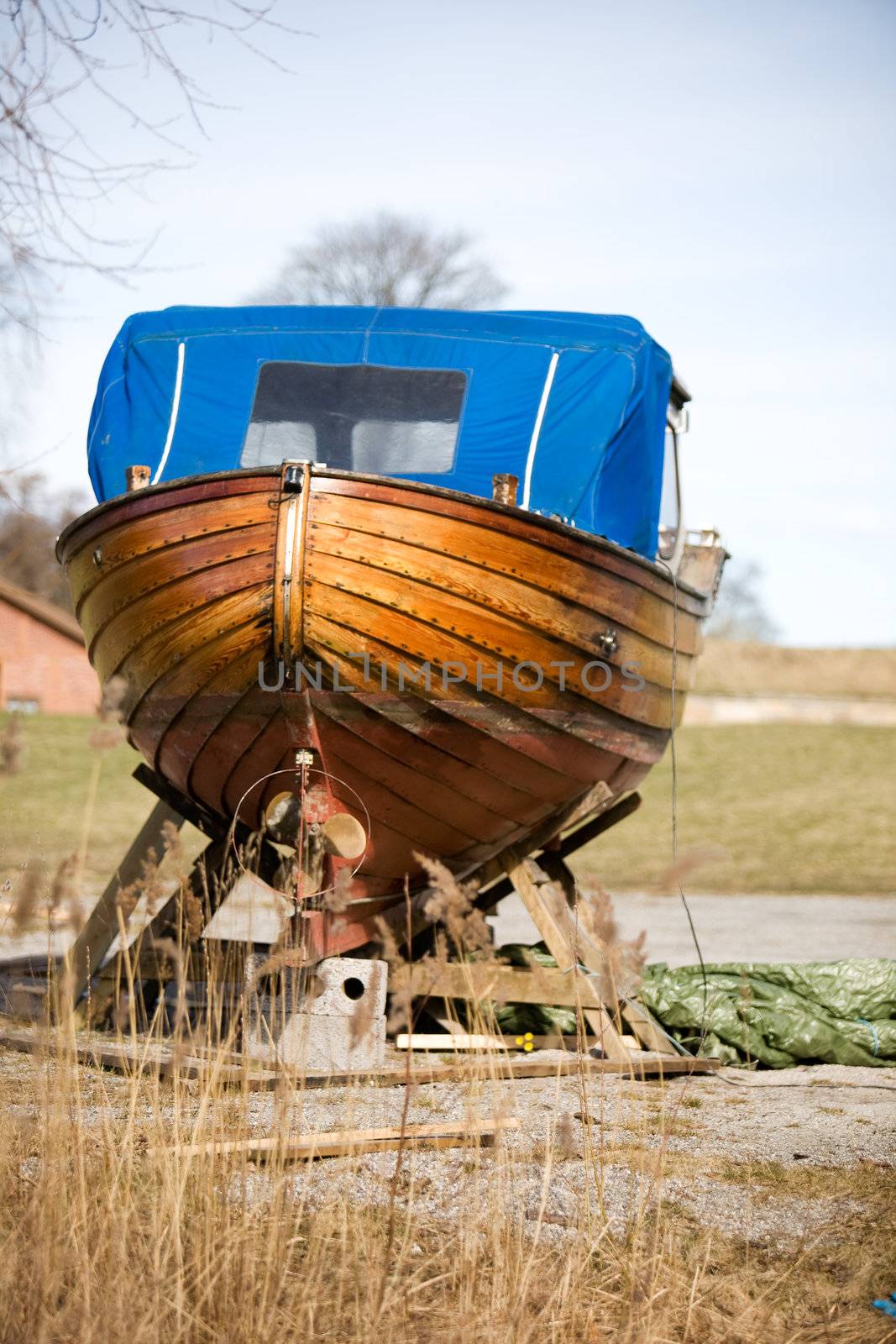 An old traditional Norwegian boat in the harbour for repair.