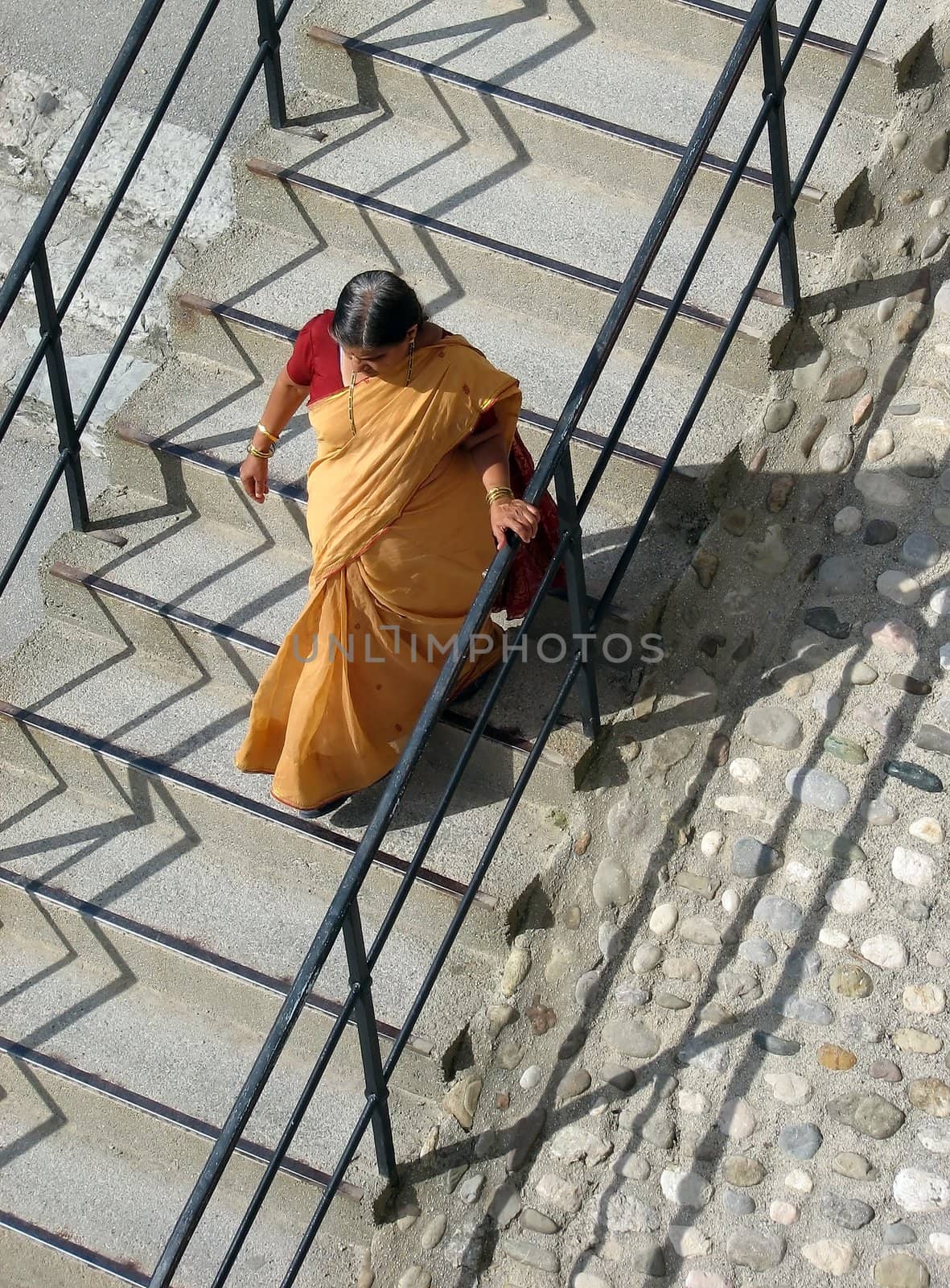 Indian woman walking down some stairs