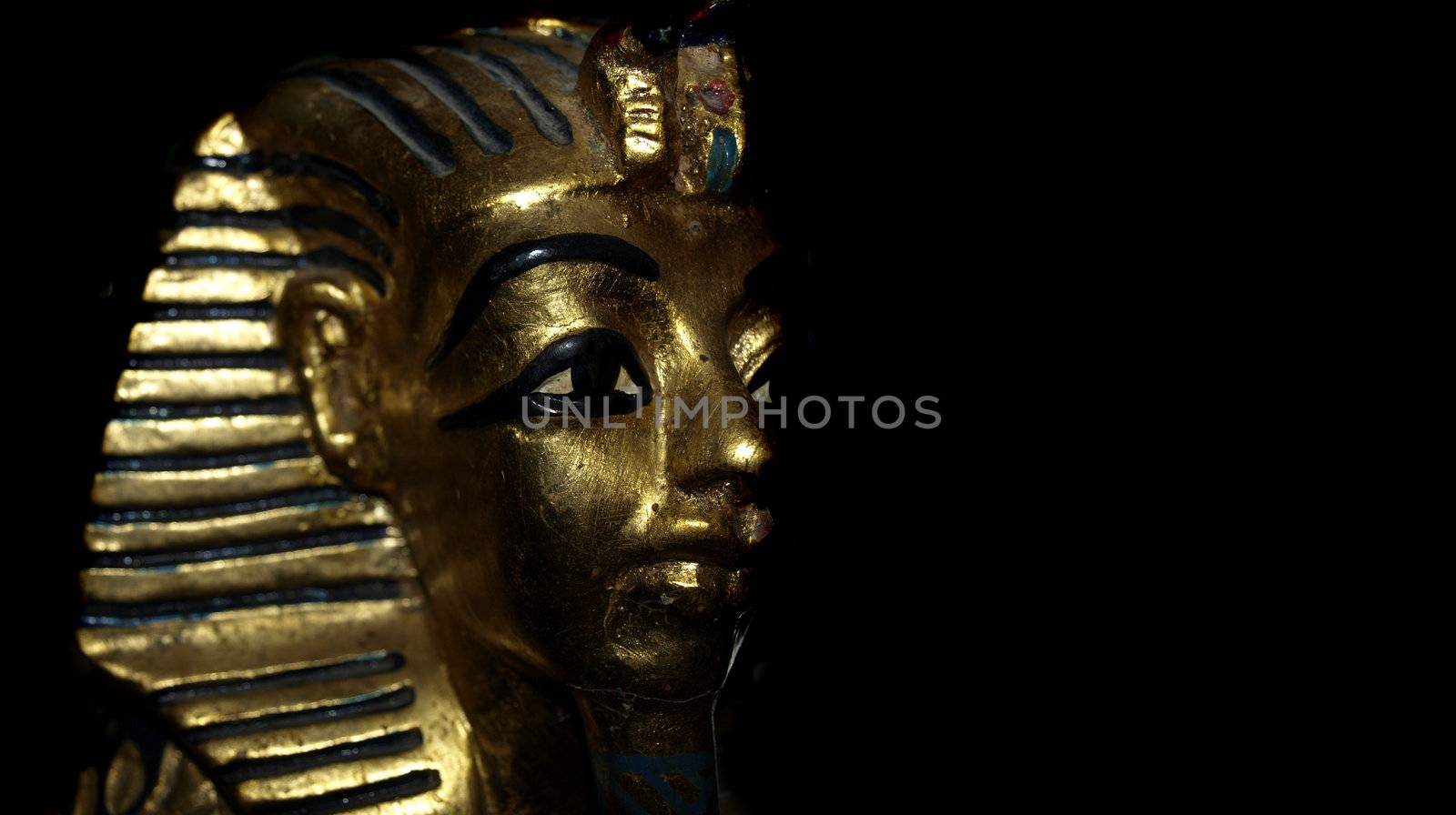 Gold mask motif of the ancient boy Pharaoh in Egypt