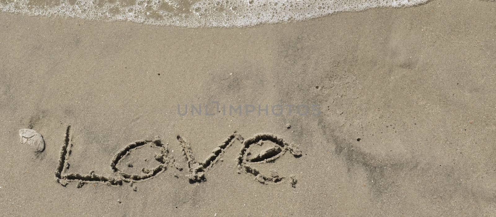 Love written in the sand with wave 7