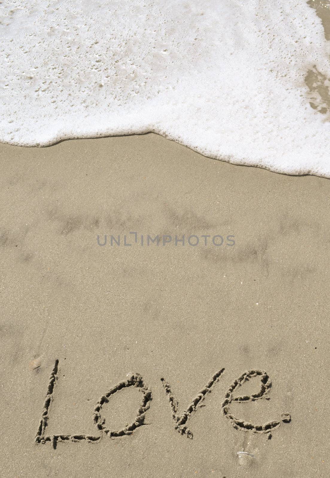 Love written in the sand with wave 12
