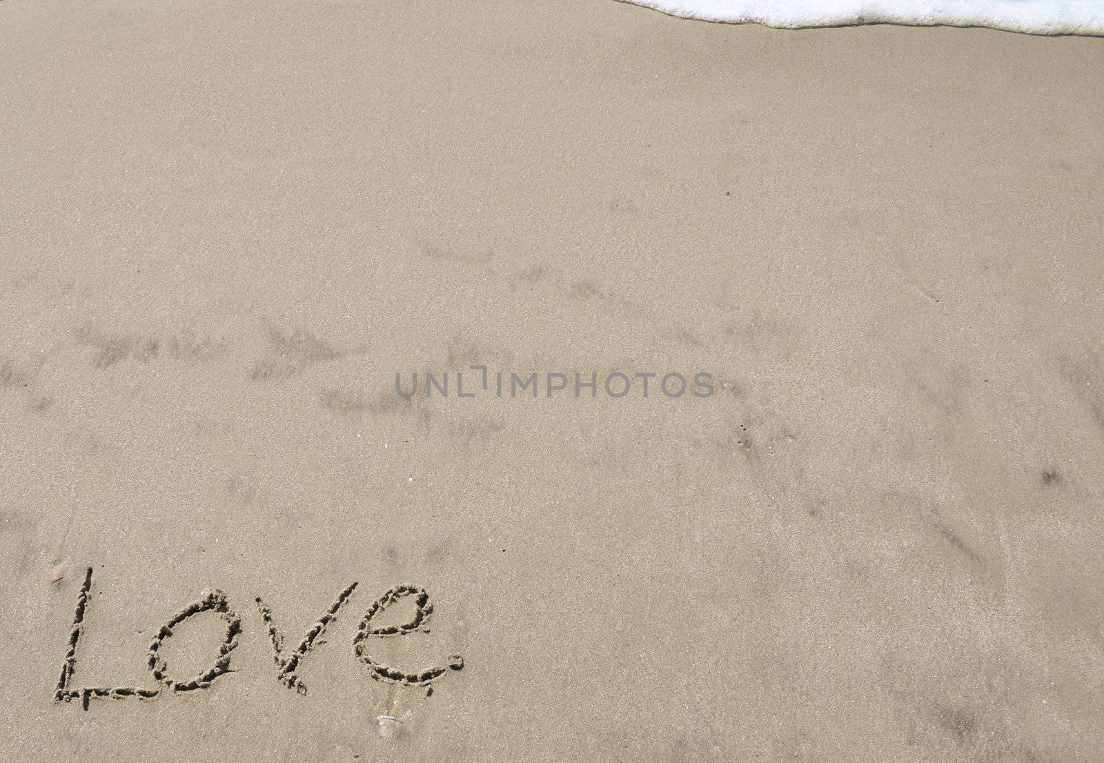 Love written in the sand with wave 9