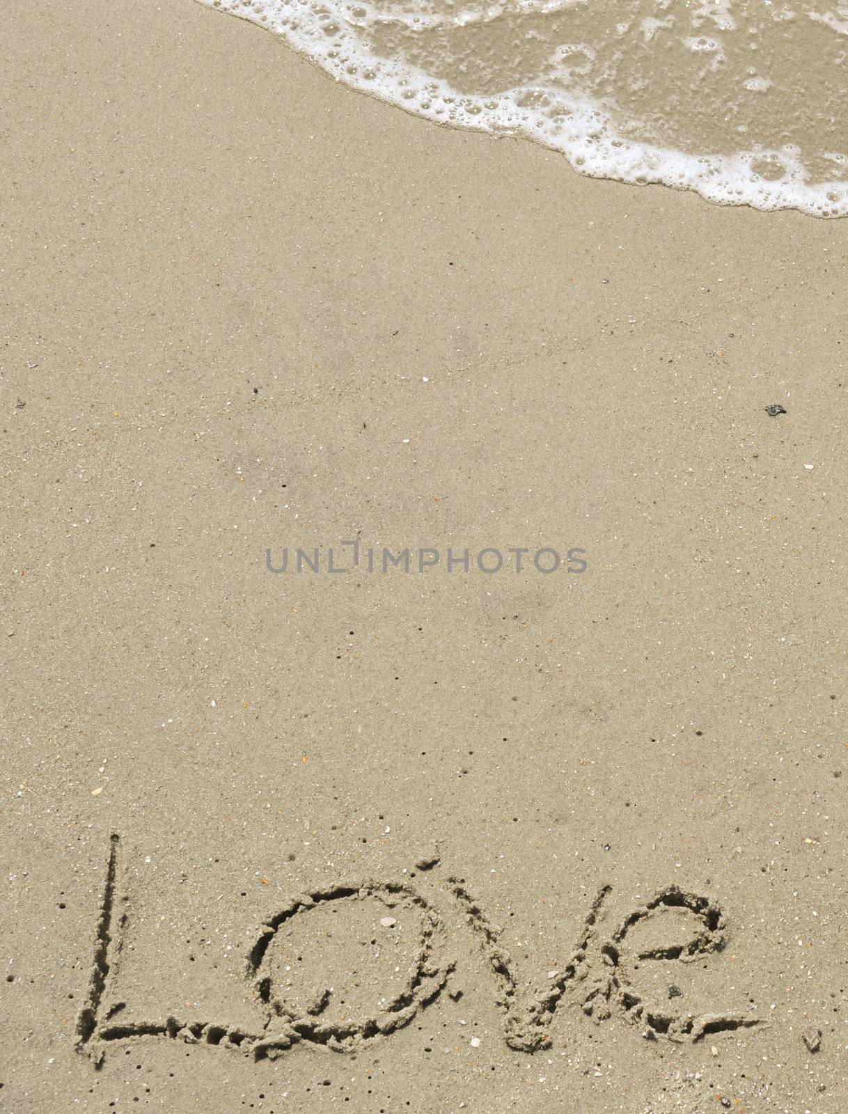 Love written in the sand with wave 16