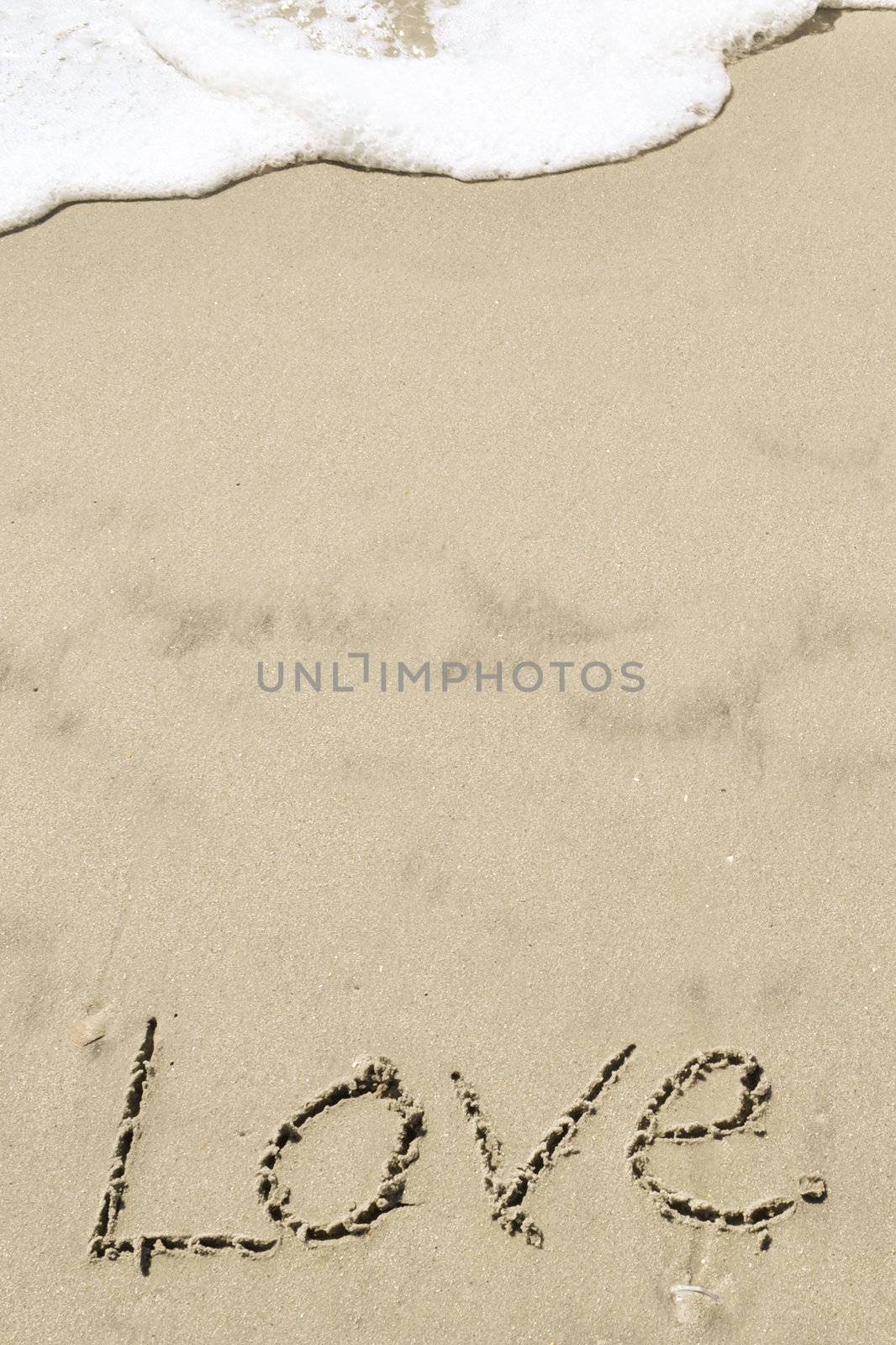 Love written in the sand with wave by RefocusPhoto