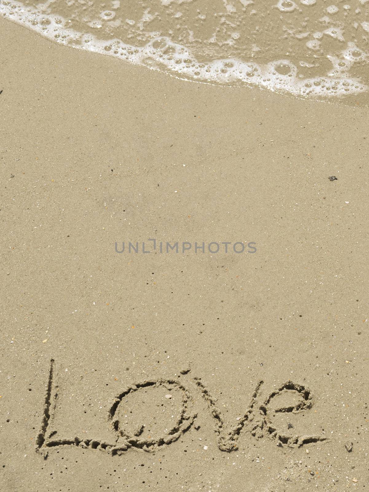 Love written in the sand with wave by RefocusPhoto