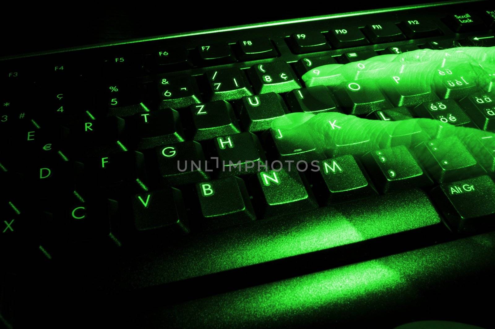 computer keyboard with ghost fingers at night