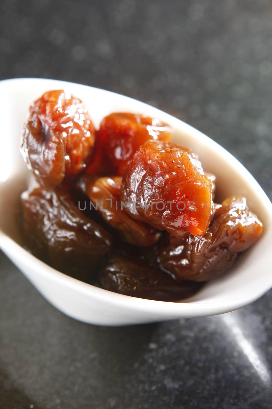 Preserved fruit, plum on the dish.