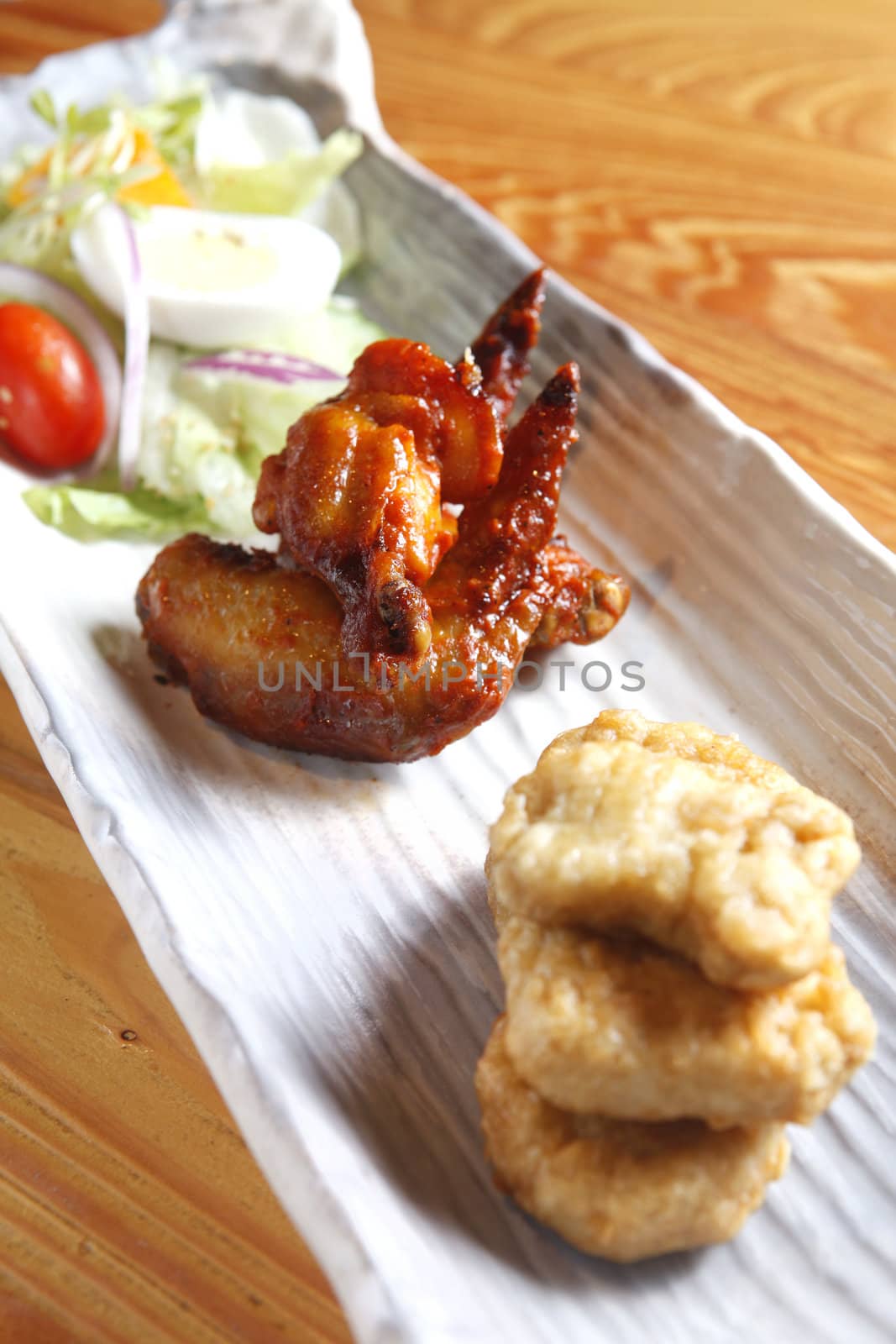 Appetizer include chicken wing, nugget and salad.
