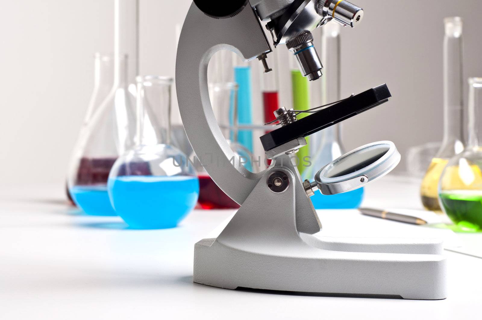 microscope and laboratory flacks colored liquid background