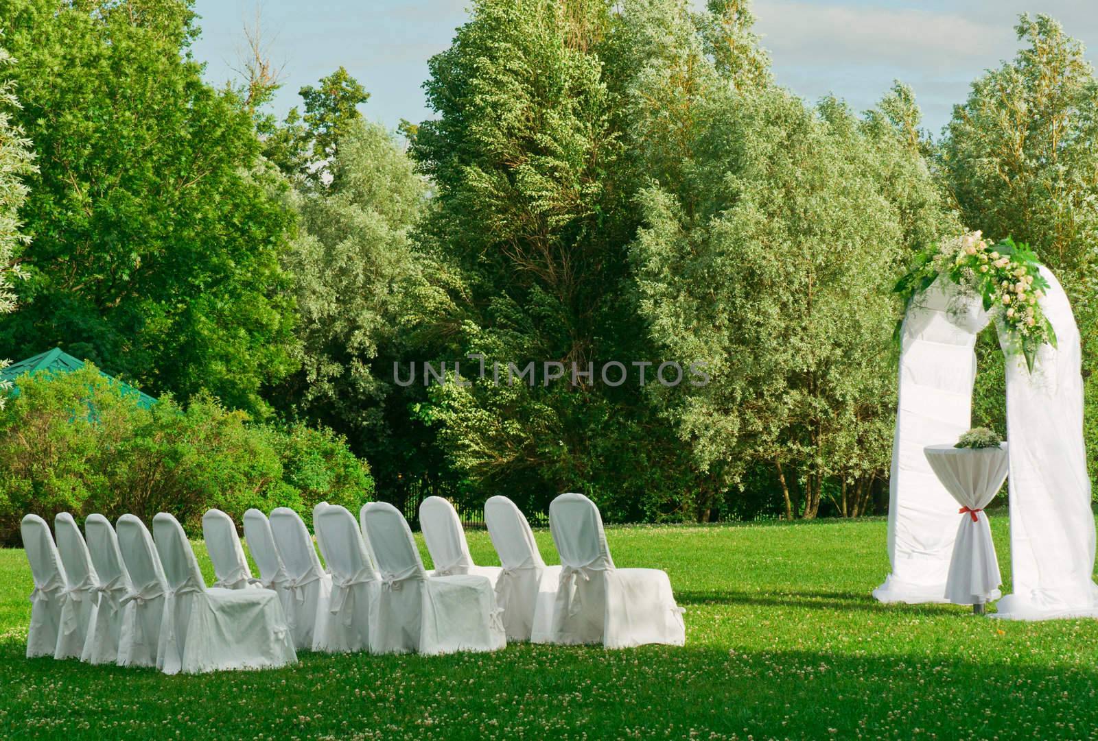 Beautiful setting for outdoors wedding ceremony waiting for bride and groom and guests