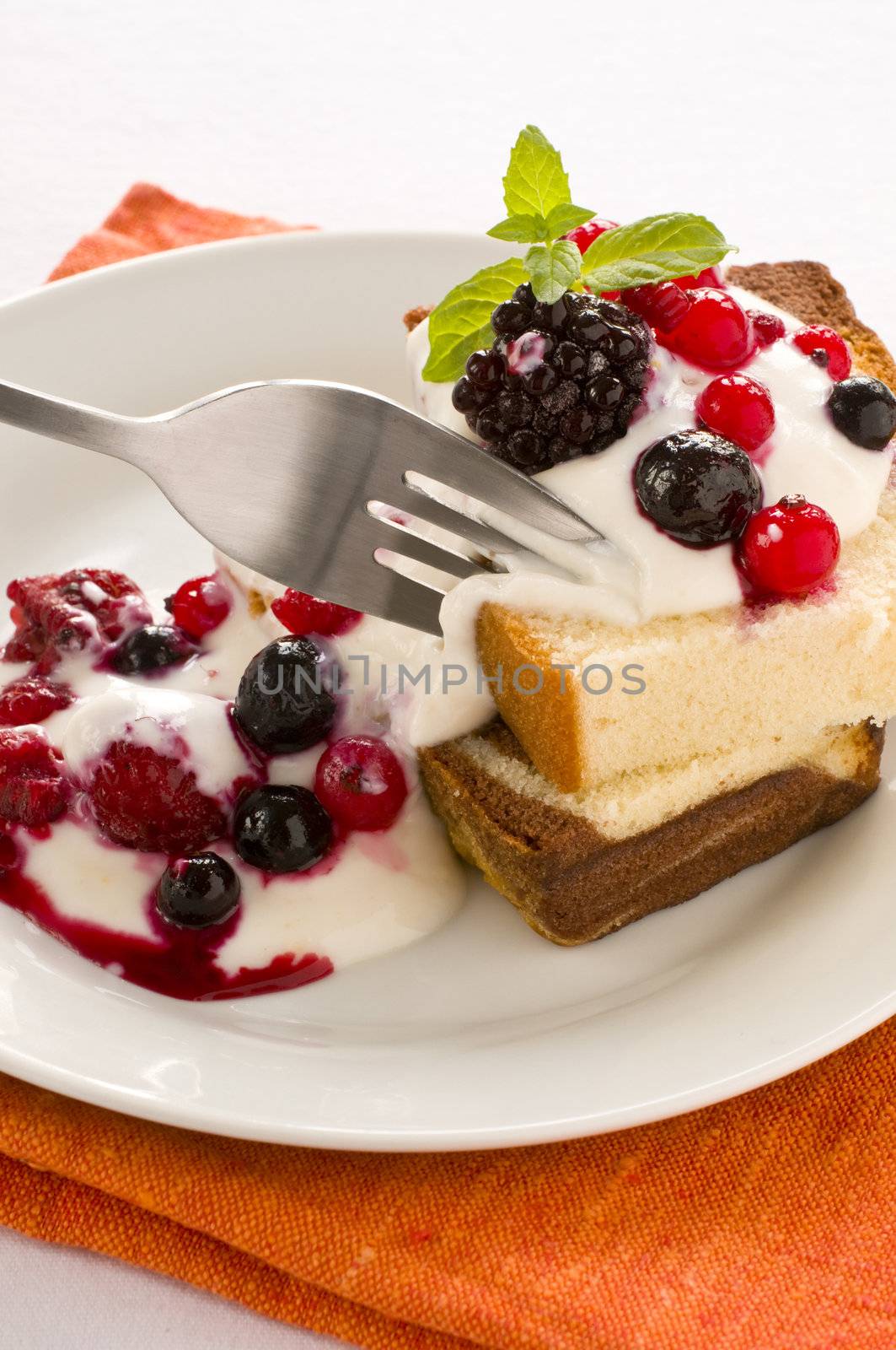 Dessert cake with yoghurt, fruits and mint leaf