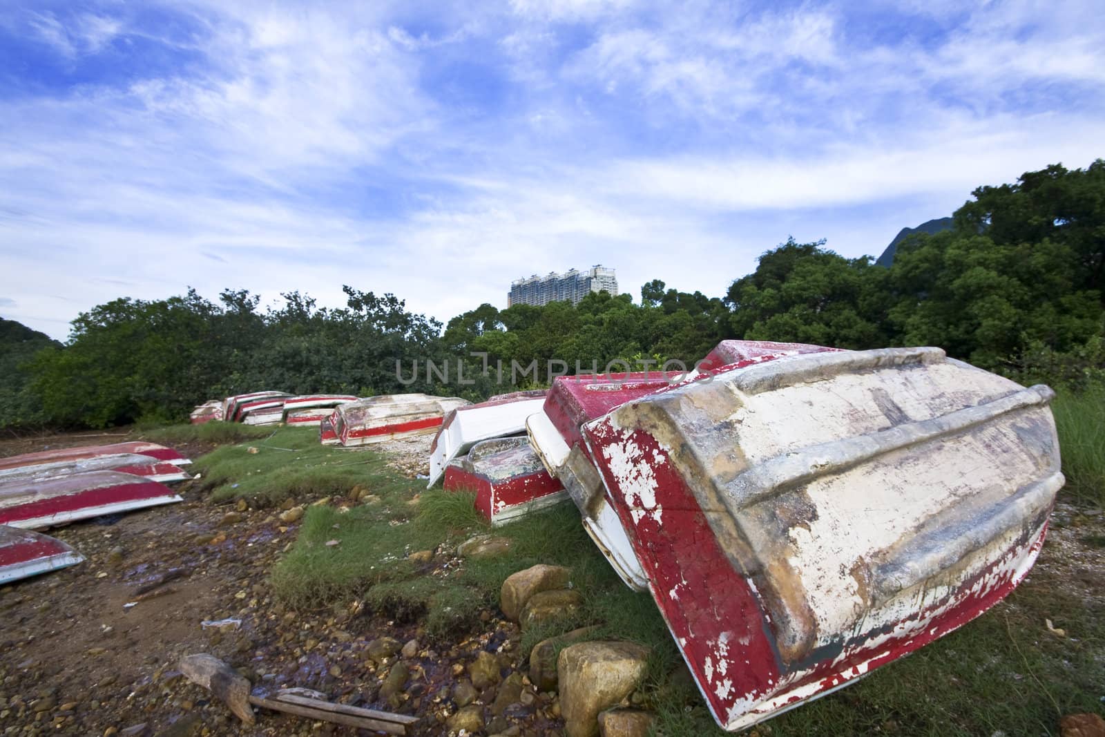 Old fish-boat on sandy beach and blue sky