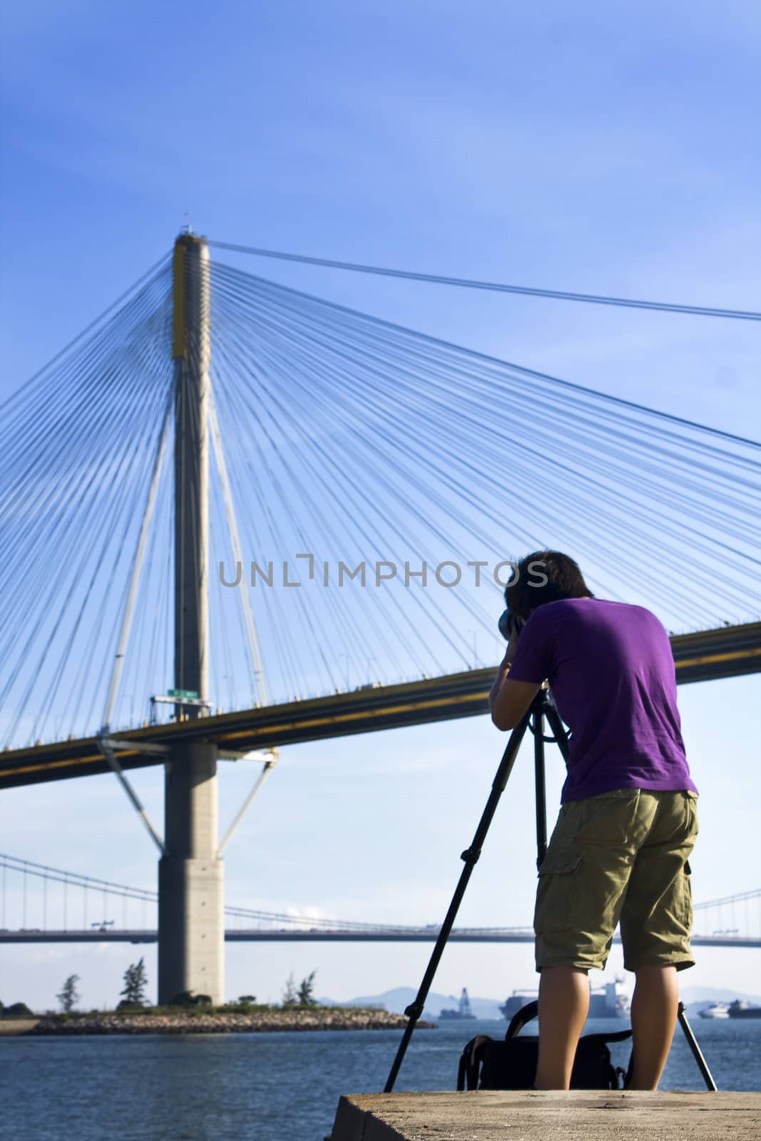 man take photo of the bridge at day