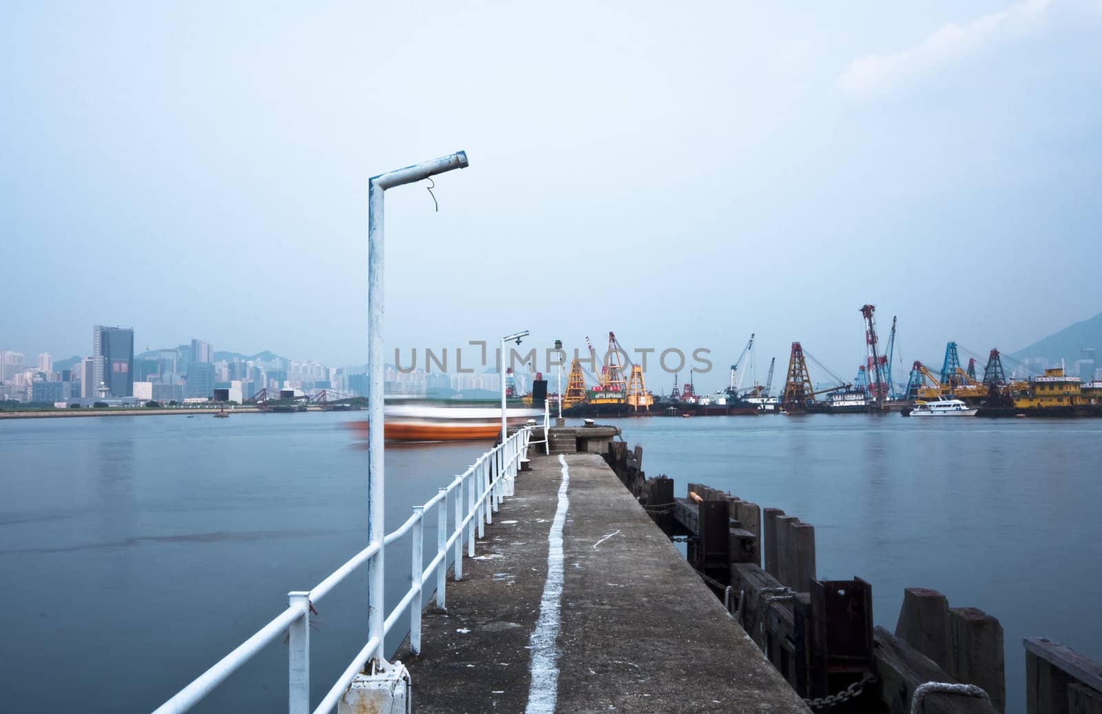 Deserted jetty at a foggy sea near a dutch city. hongkong