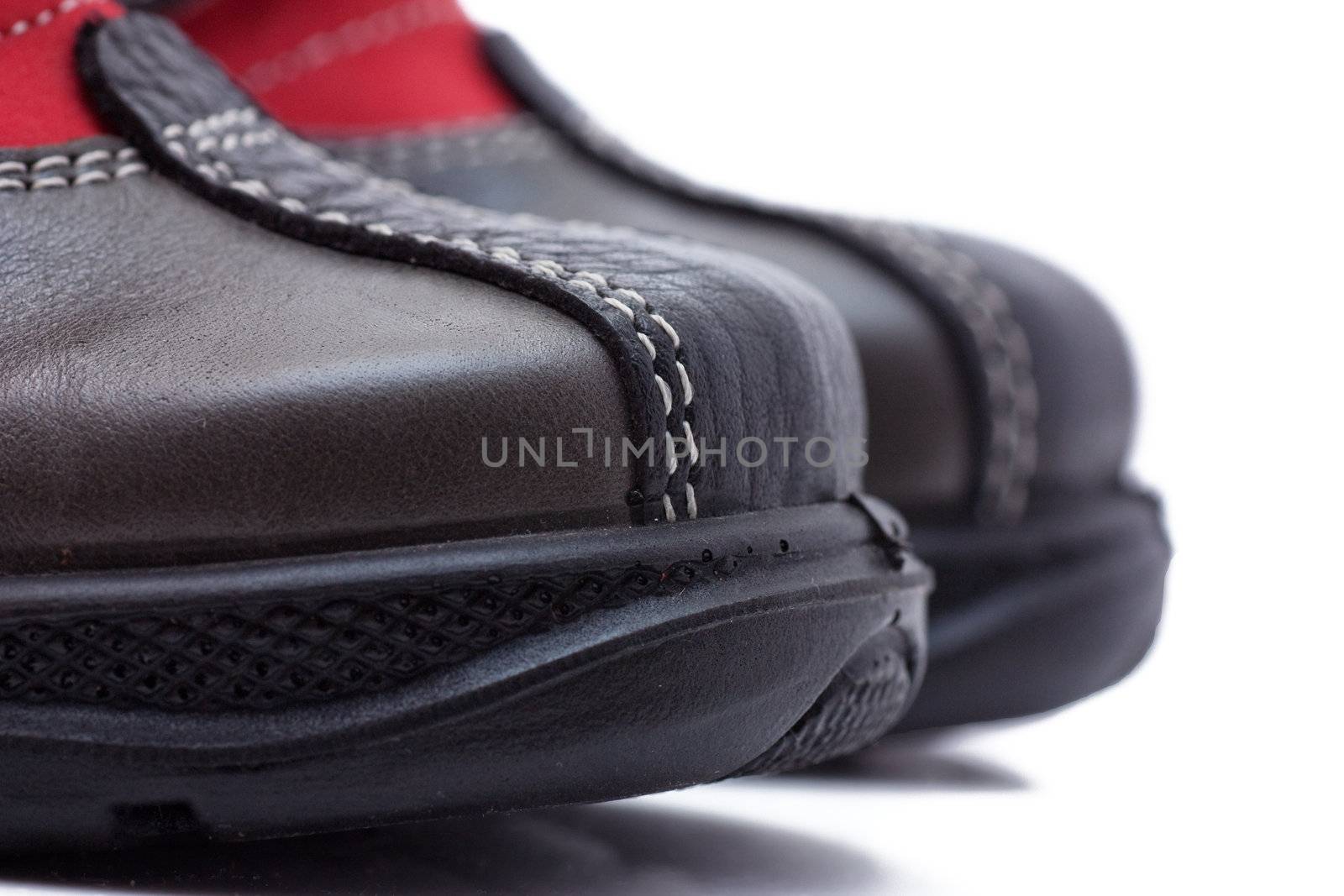 Macro view of sole of a child shoe isolated over white