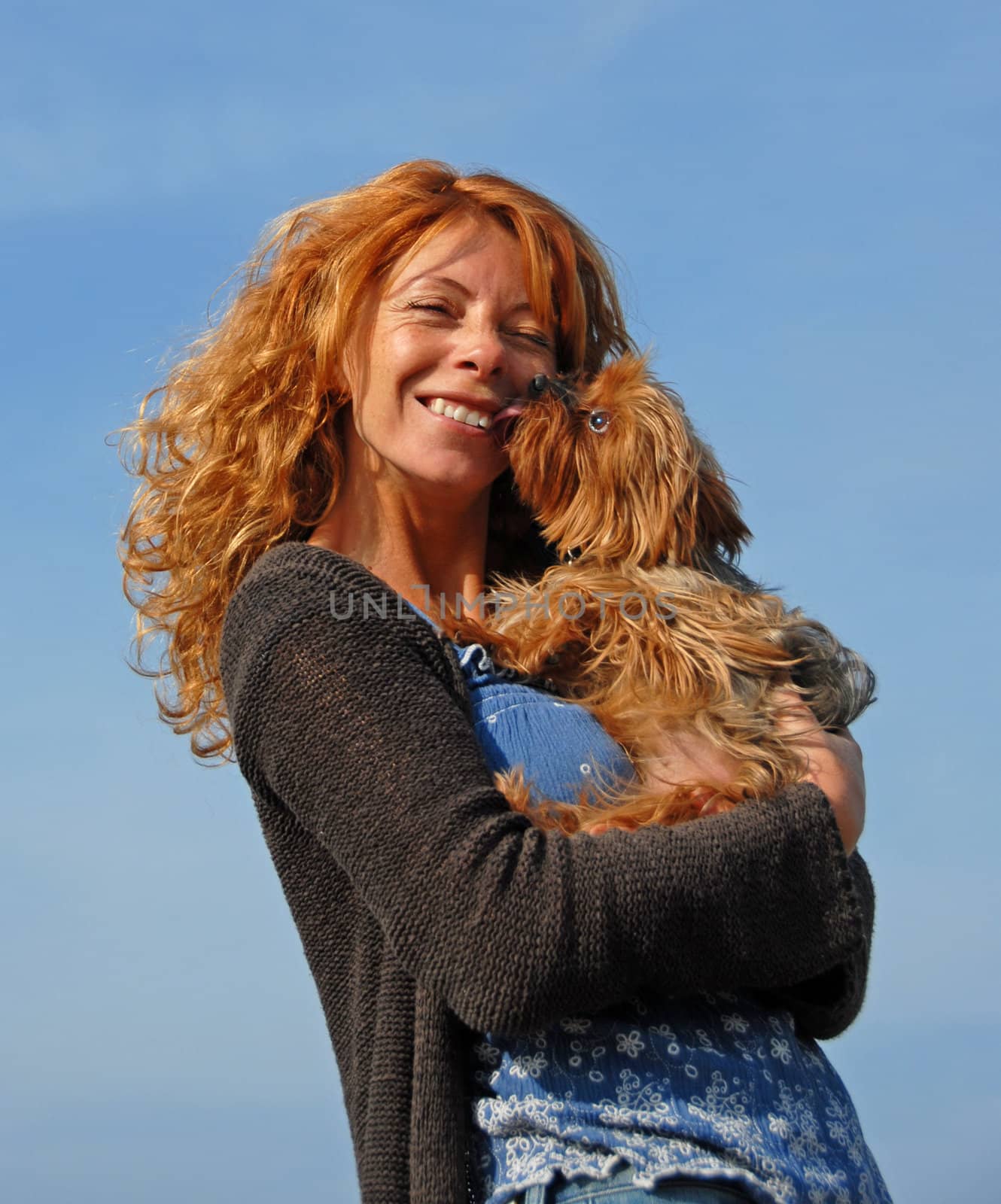 young woman with red hairs and her little purebred yorkshire terrier