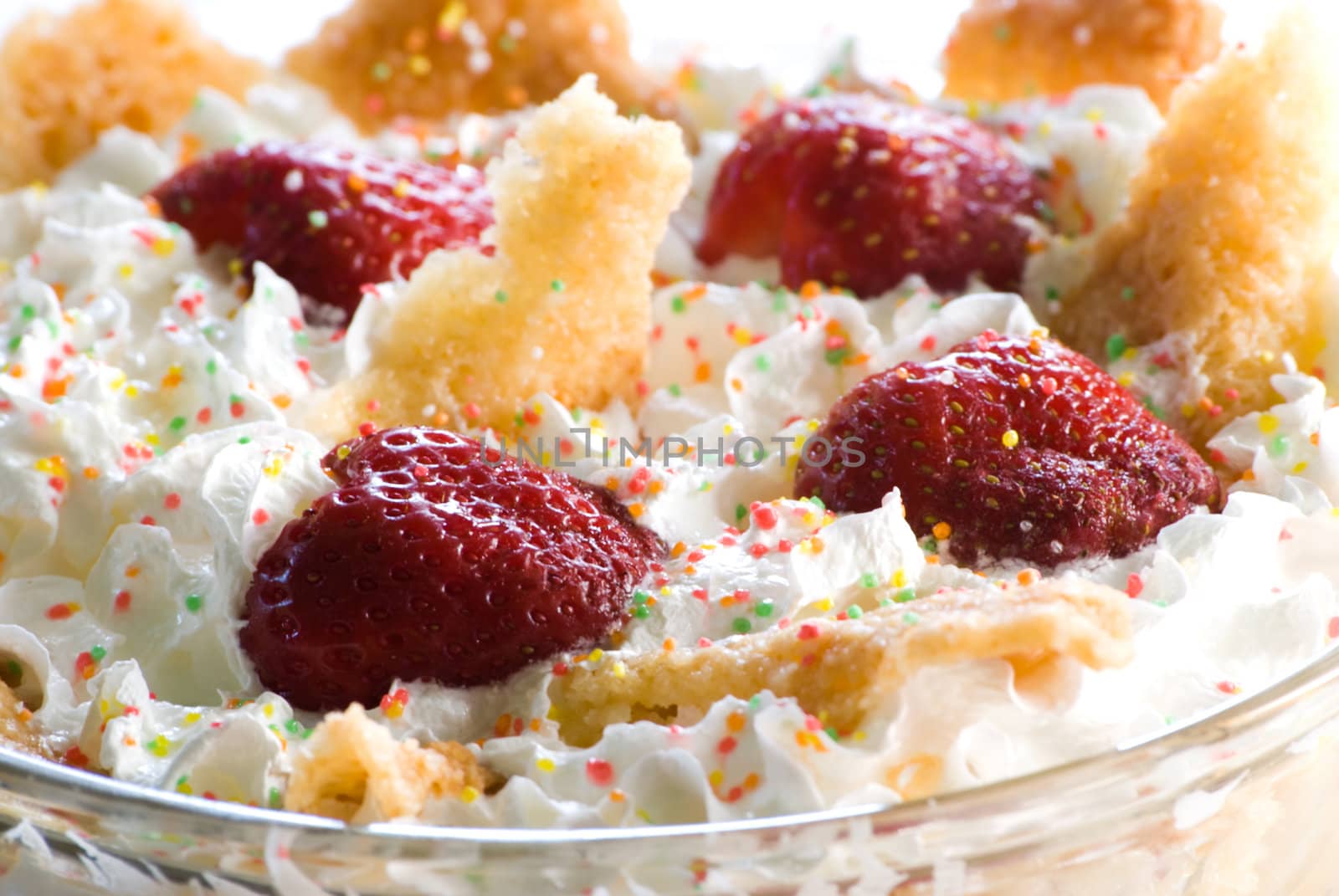 Strawberry dessert with whipped cream and colorful sprinkles