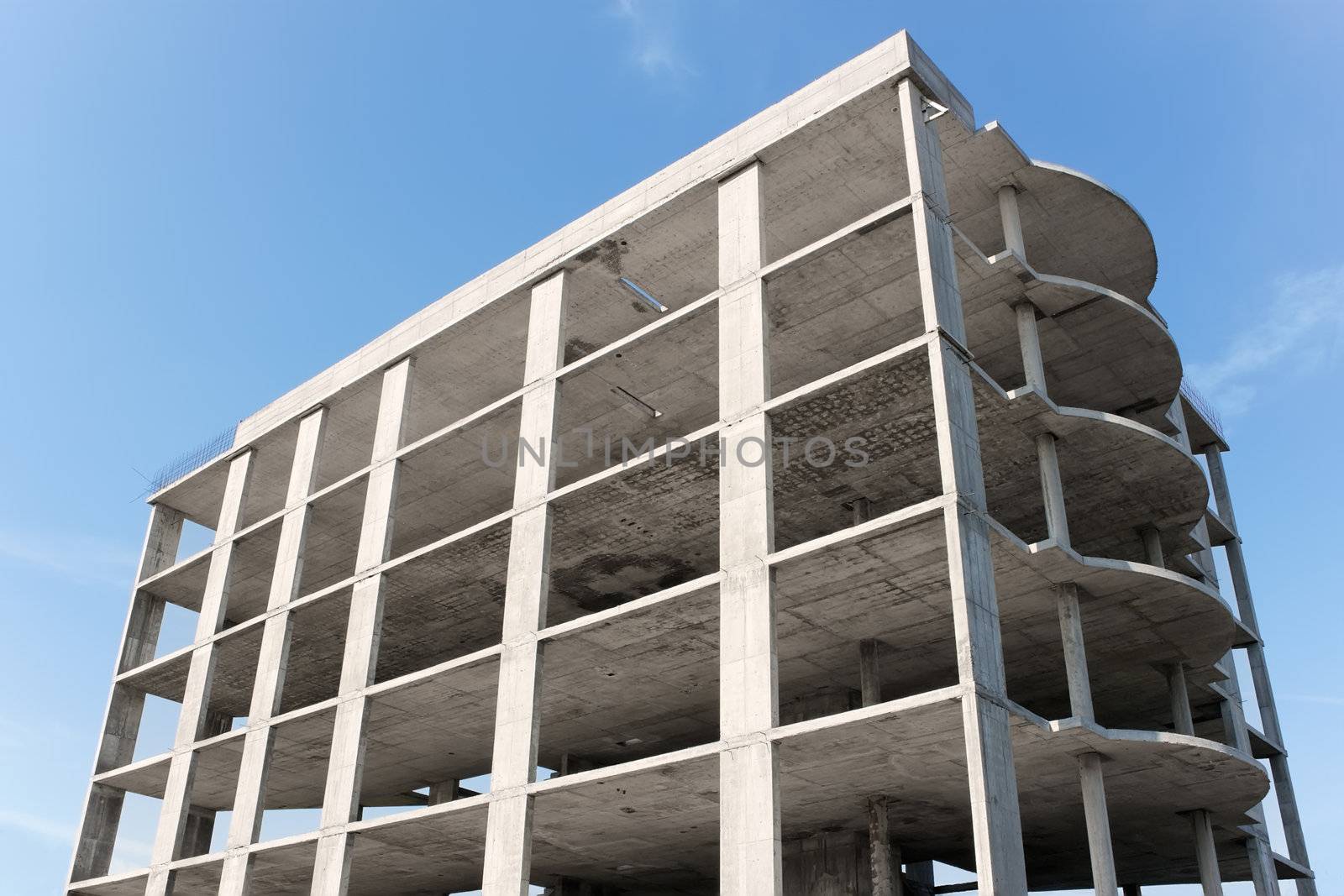 A multi-storey building construction on the background of blue sky